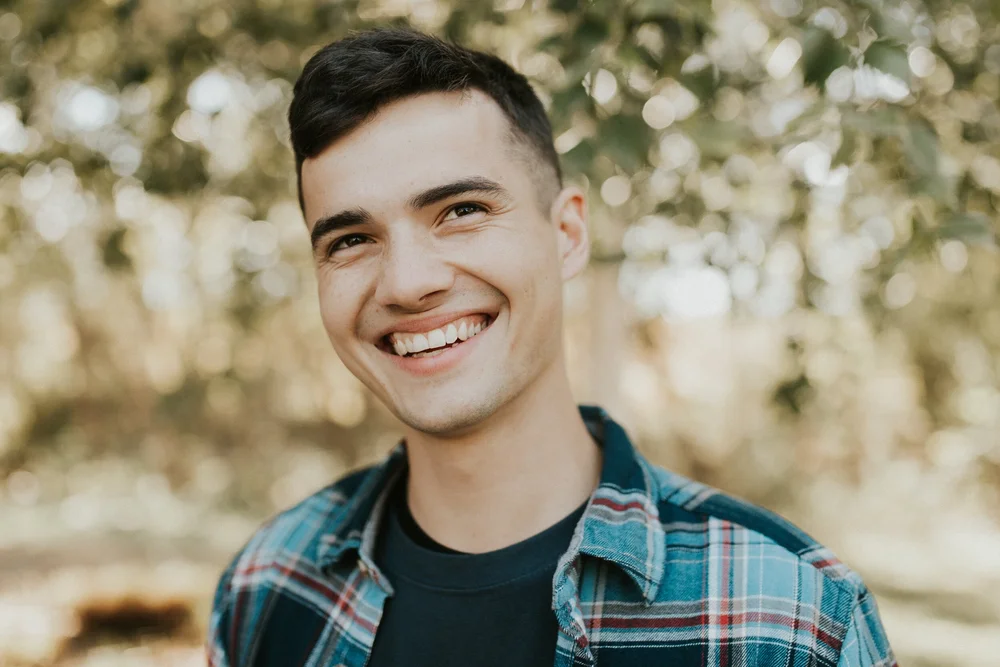 A smiling young man outdoors