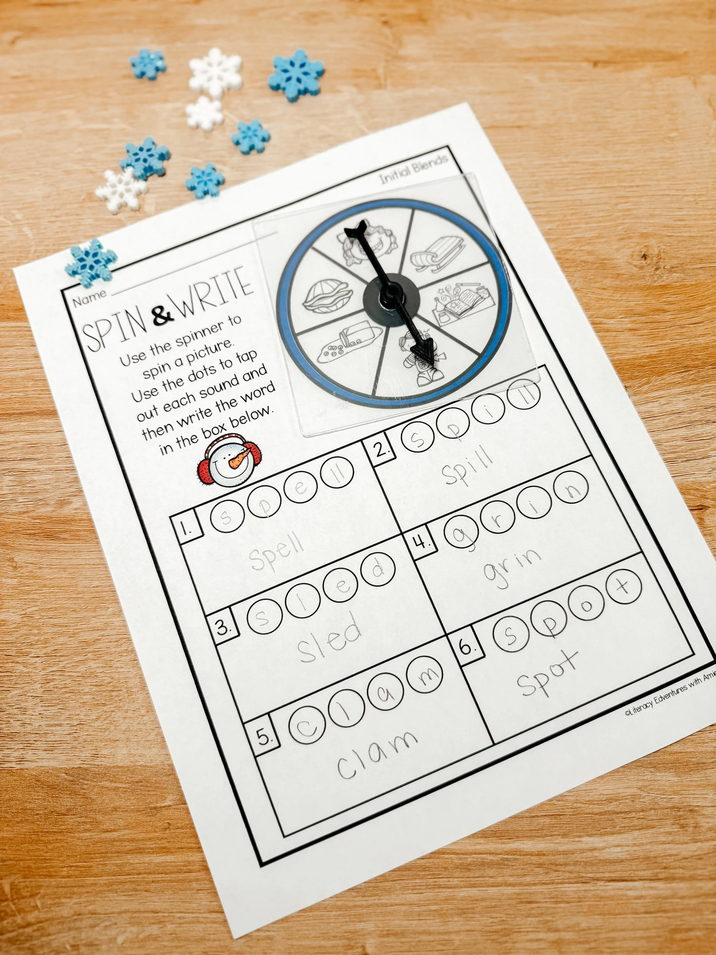 Students using winter phonics spin and write activity during literacy centers.