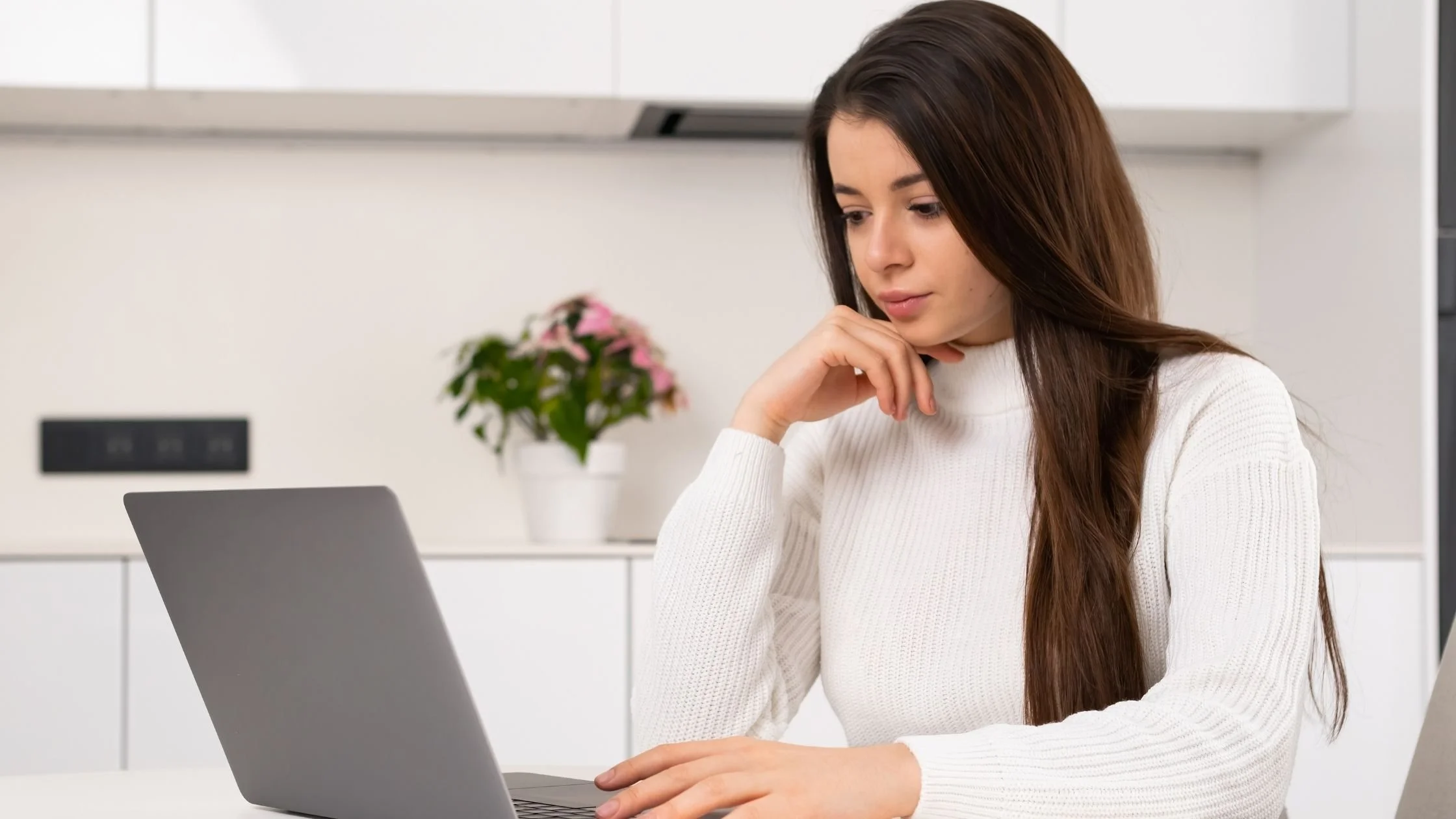 woman thinking about her business while looking at a laptop minimalist