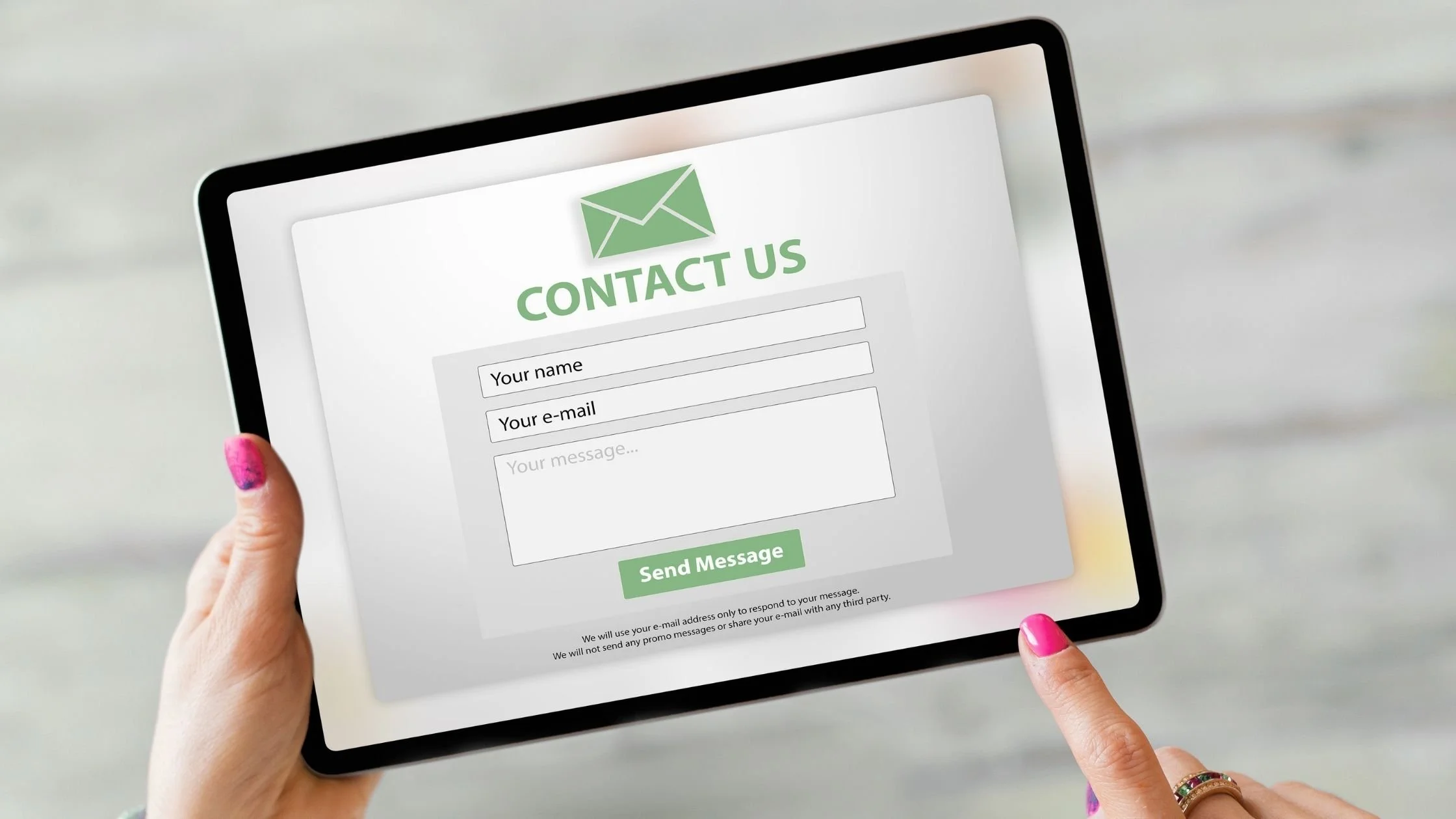 woman holding a touch screen ipad tablet using a website contact form