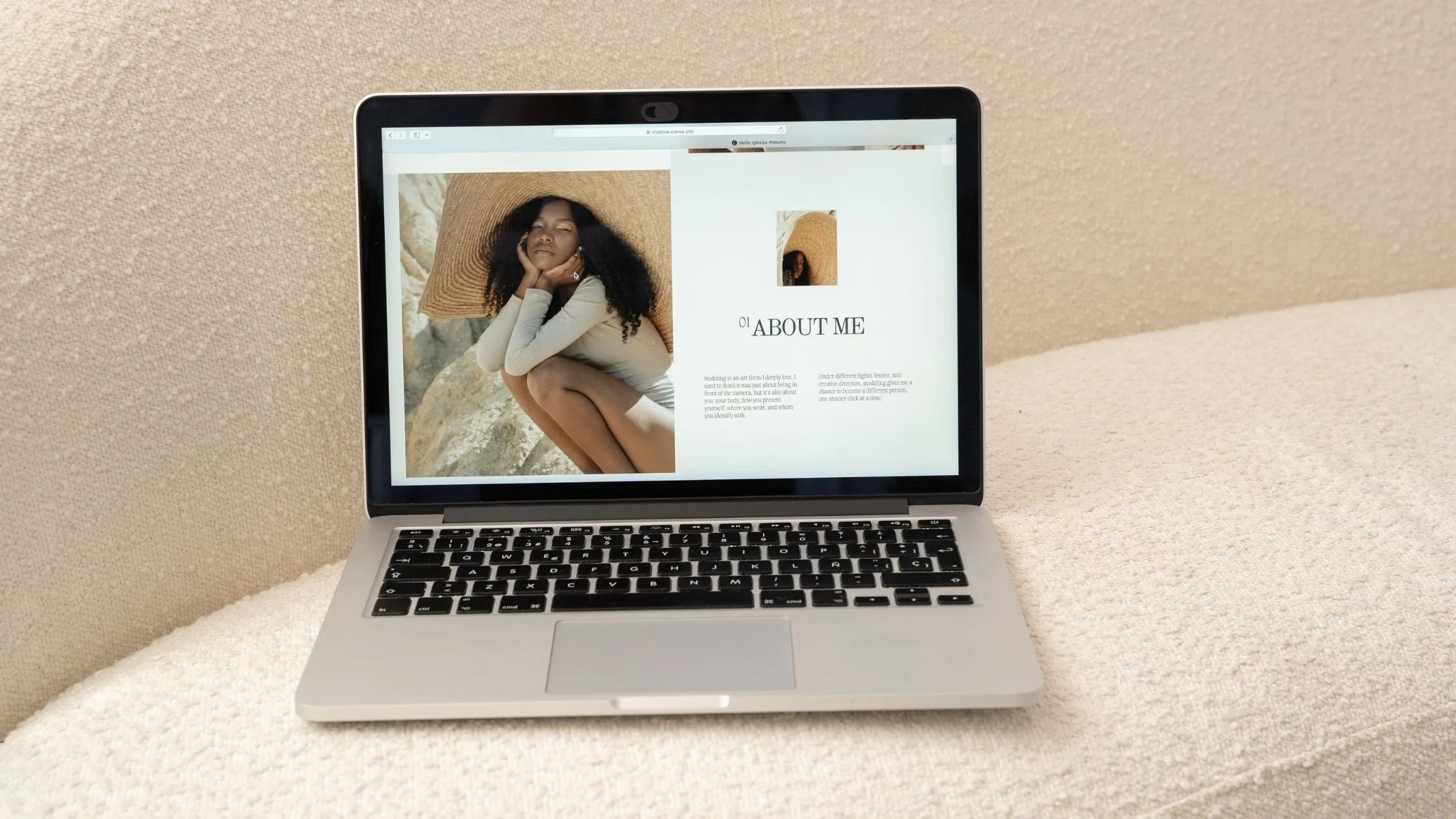 laptop on a beige modern minimalist couch displaying clean and modern website
