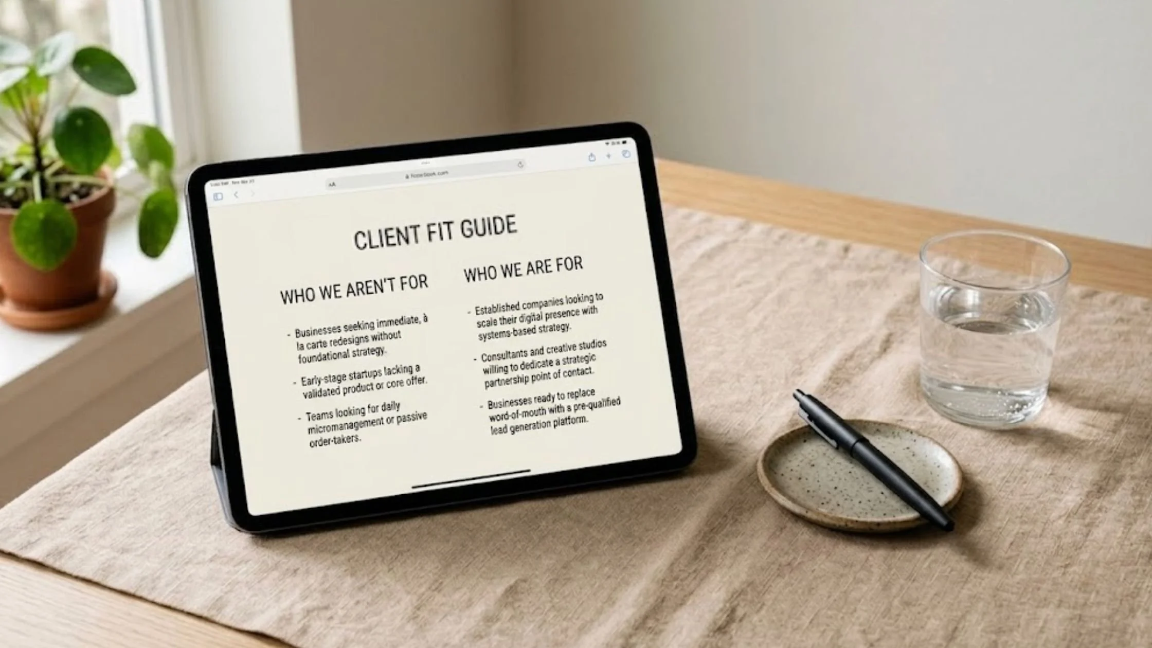 iPad displaying a clean services page layout on a minimalist desk.