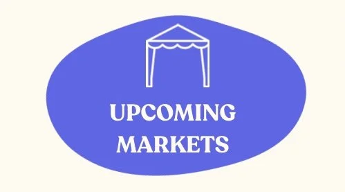 Blue oval sign with a white tent illustration and the words "UPCOMING MARKETS" in white text.