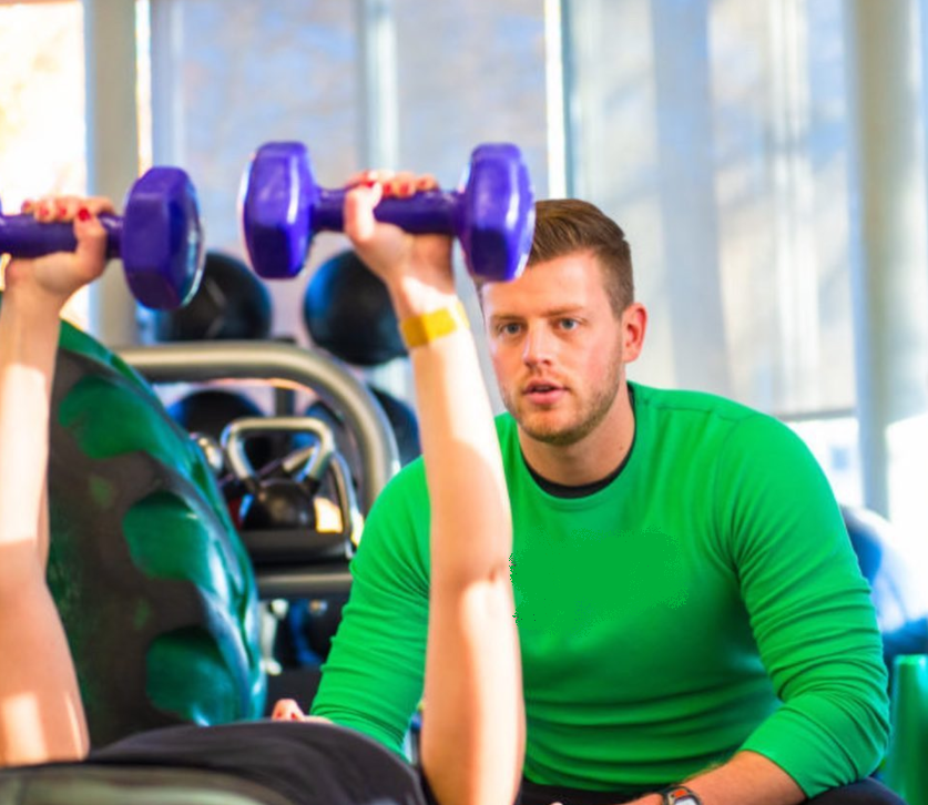 Sam coaching a client through a strength-training exercise