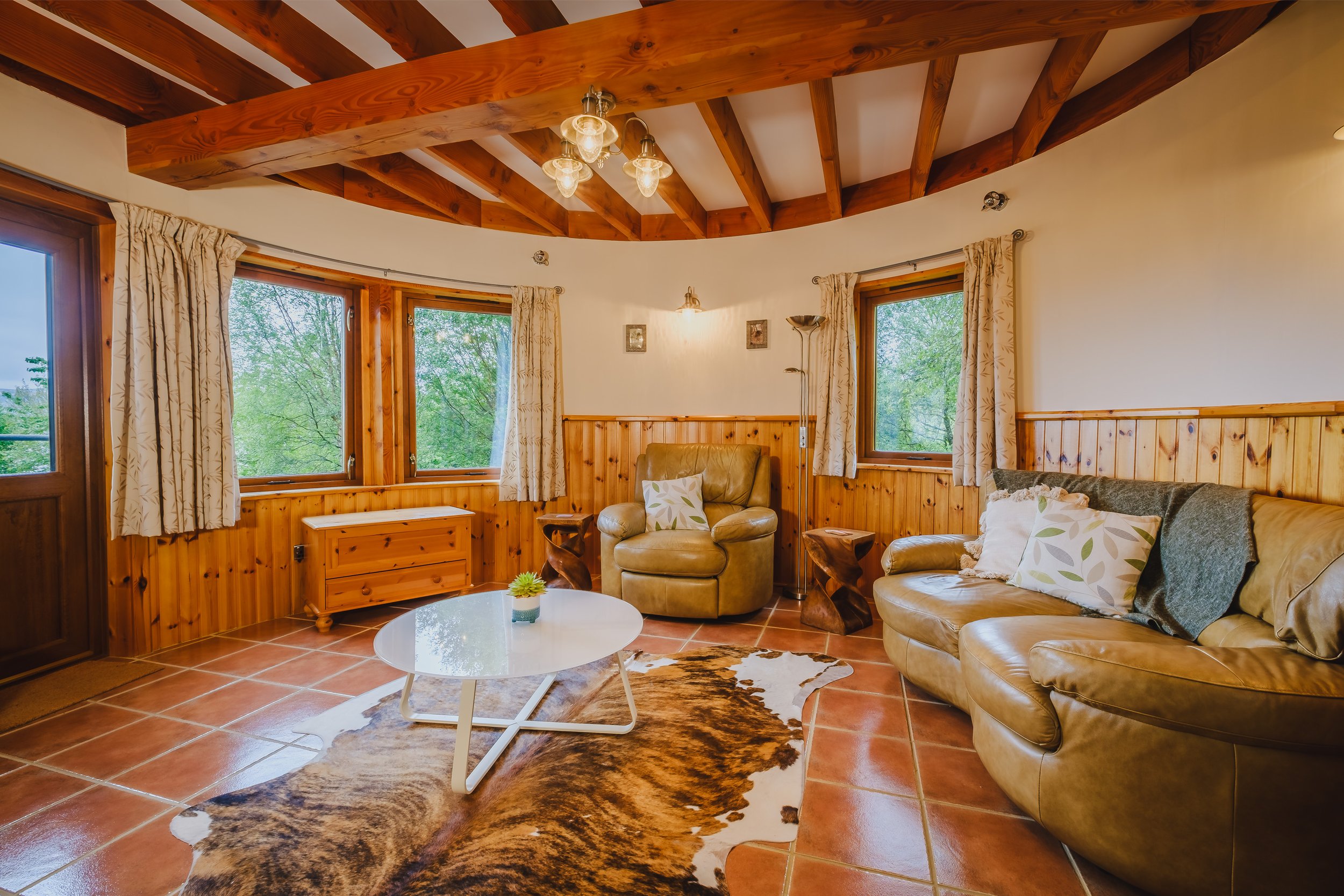 Living room with wood-burning stove overlooking woodland and Loch Sunart. Usige Beo Self catering cottage on the shores of Loch sunart,  Ardnamurchan (Copy)