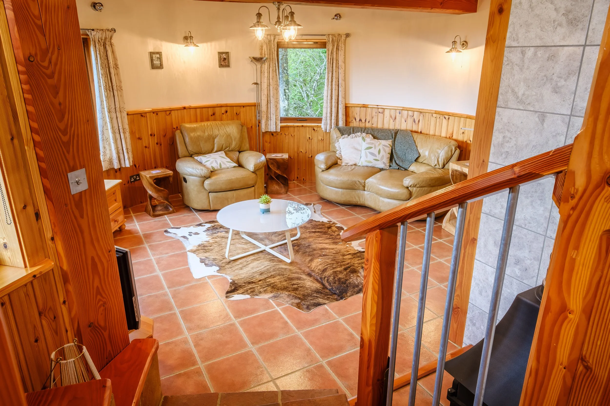 Living room with wood-burning stove overlooking woodland and Loch Sunart. Usige Beo Self catering cottage on the shores of Loch sunart,  Ardnamurchan (Copy)