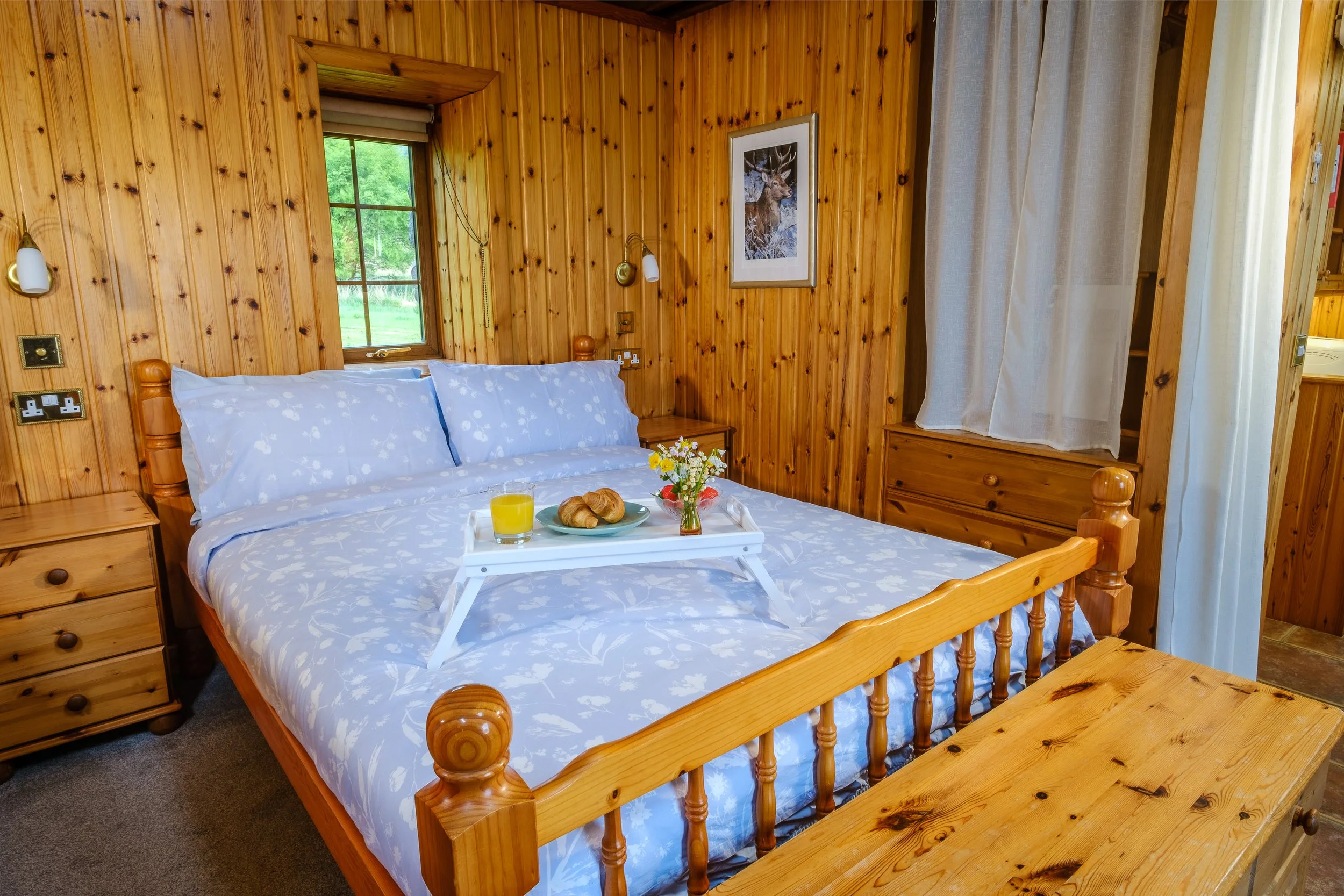 Double bed and cozy open plan living room with wood burnign stove. Camas bàn cottage, self catering cottage for 2 -4 people on the shorefront of Loch Sunart, Ardnamurchan (Copy)