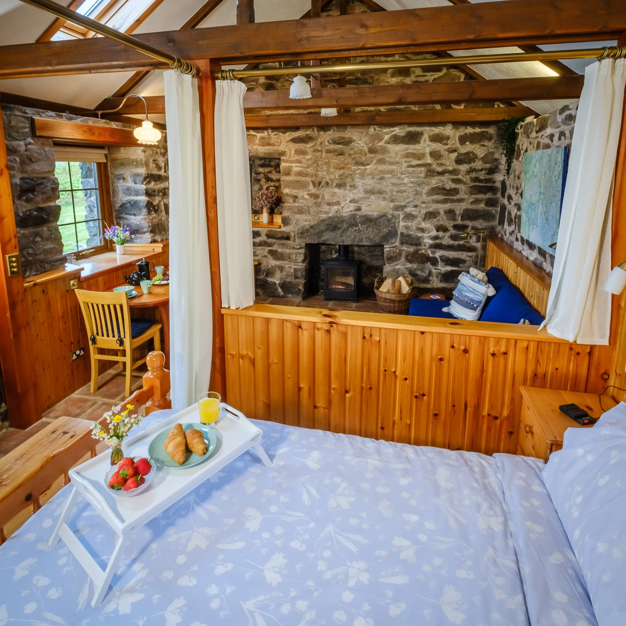 Double bed and cozy open plan living room with wood burnign stove. Camas bàn cottage, self catering cottage for 2 -4 people on the shorefront of Loch Sunart, Ardnamurchan (Copy)