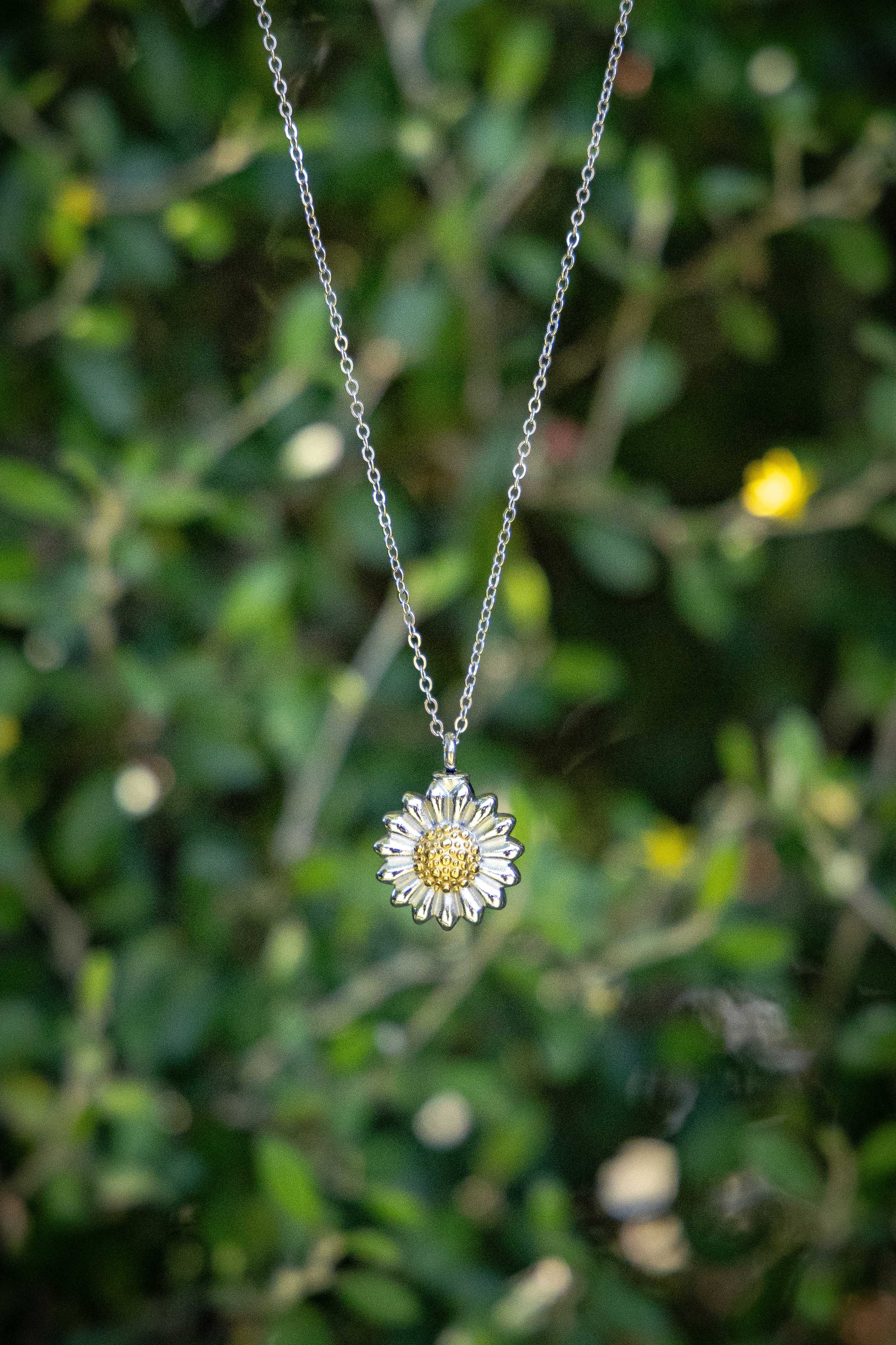 Single sunflower pendant urn in stainless steel with gold coloured centre for pet ashes