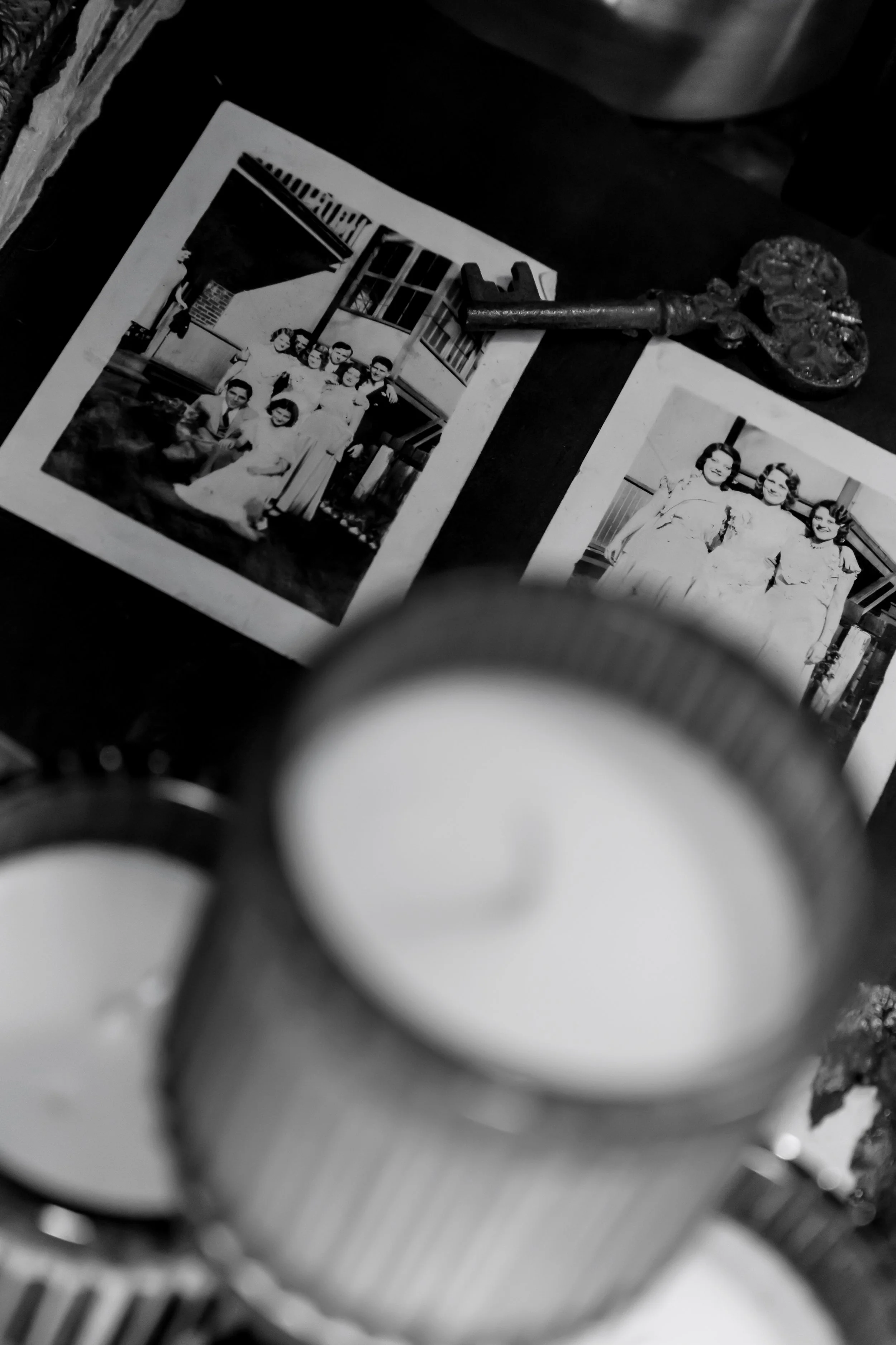 Le Reliquaire candle styled among vintage books – handmade scent framed by nostalgia, ephemera, and personal ritual.