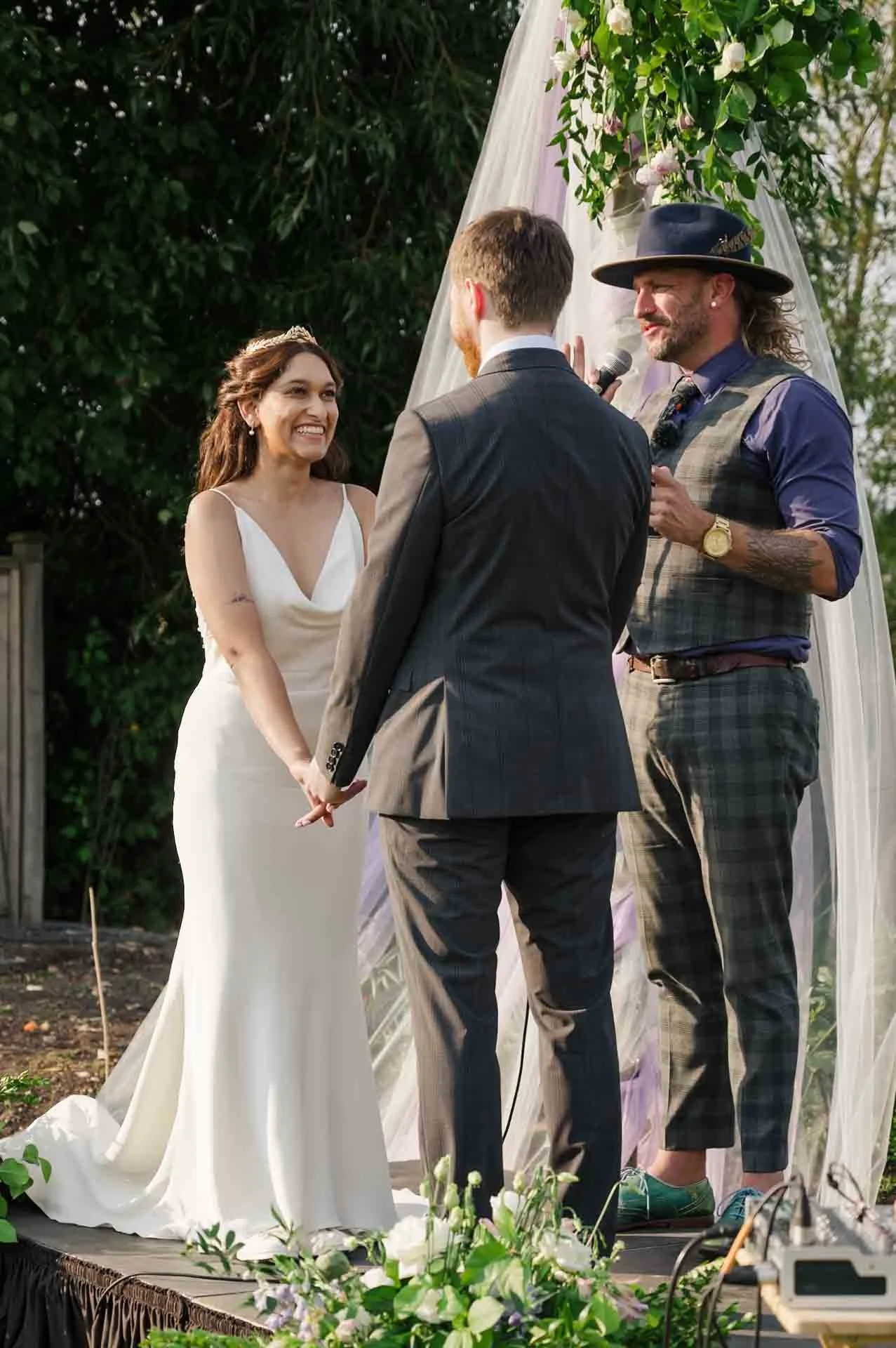 wedding officiant with bride and groom at outdoor wedding