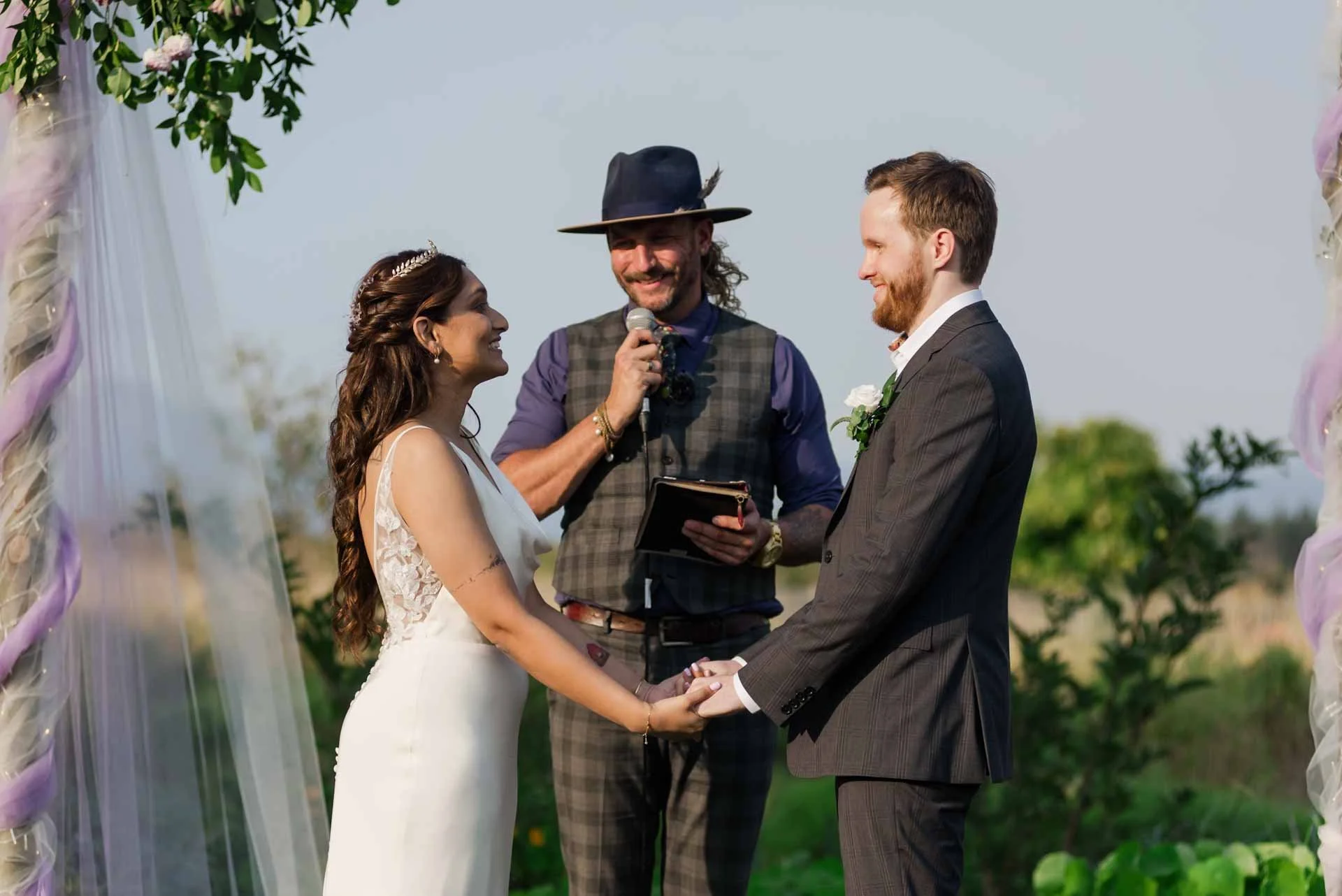 bride and groom being married by wedding officiant