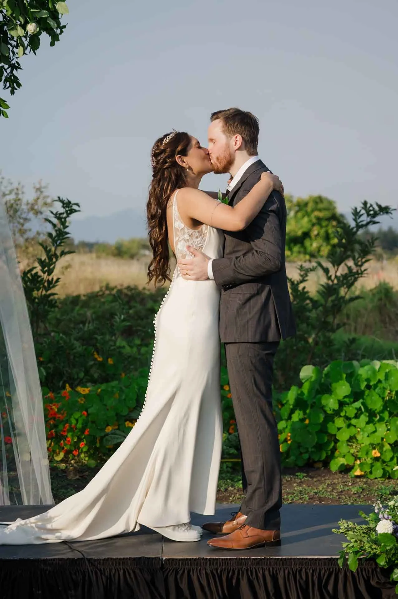 bride and groom kissing at outdoor wedding ceremony