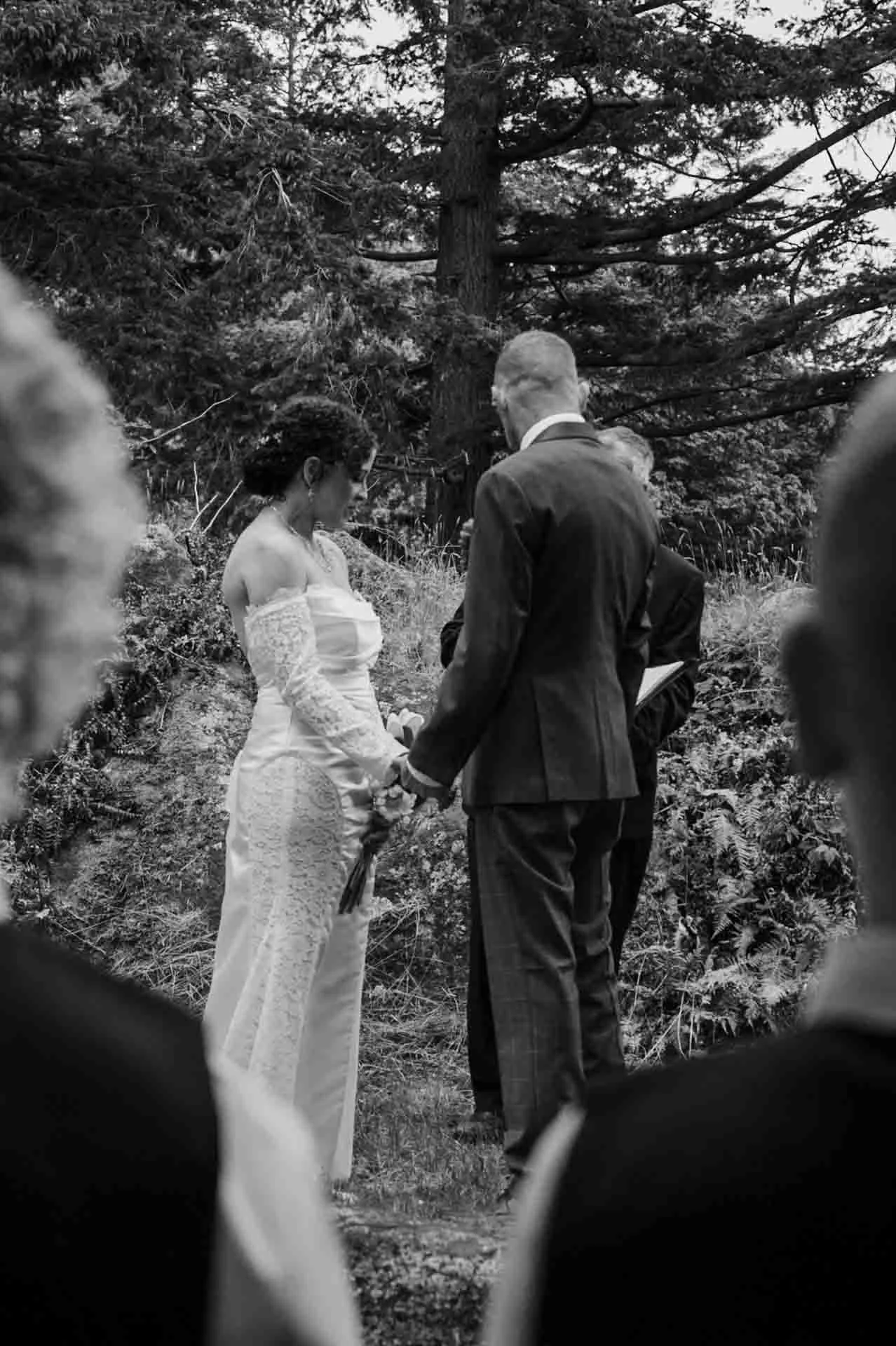 bride and groom holding hands during outdoor ceremony