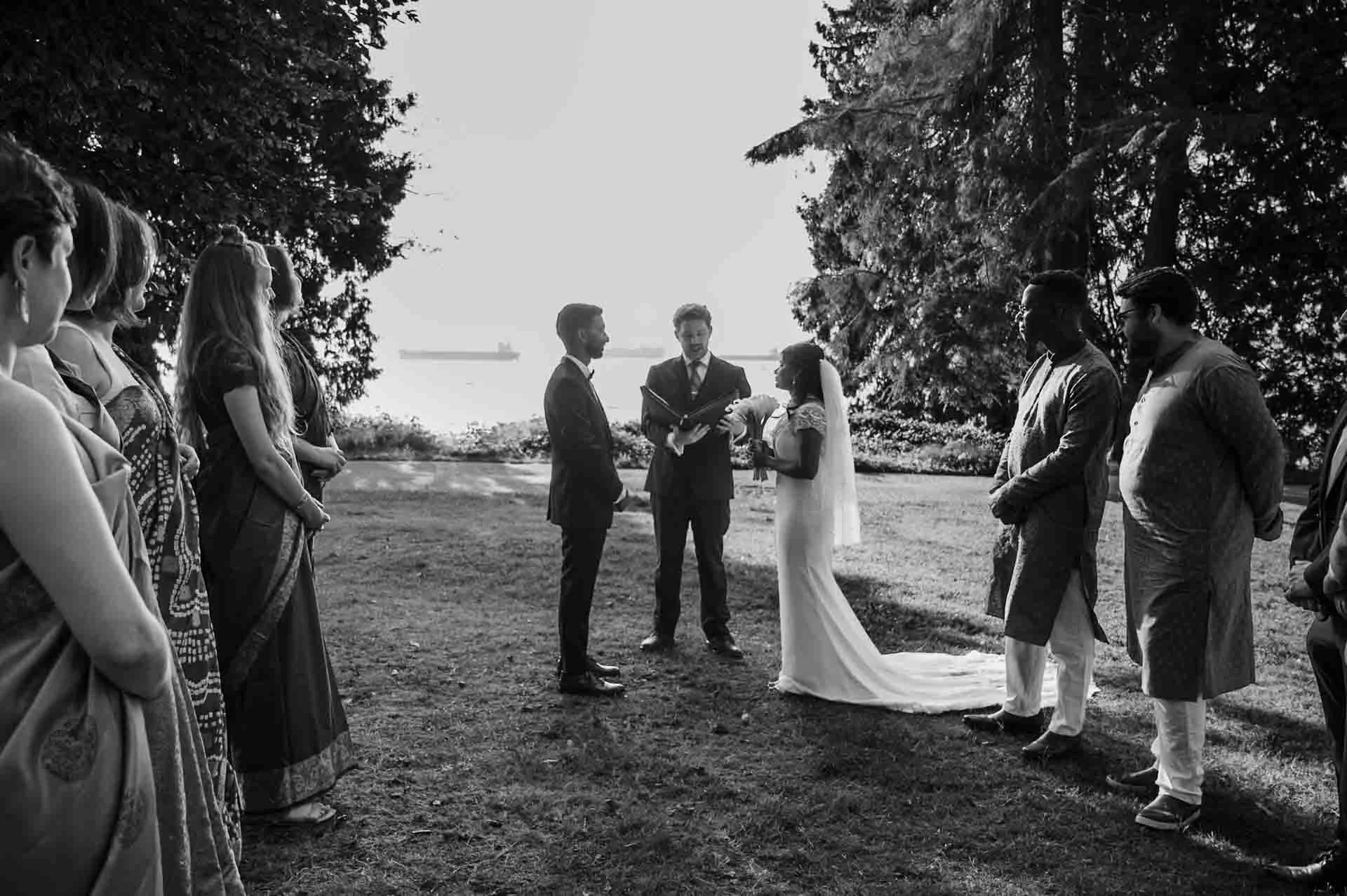 outdoor ceremony with a few guests in front of the water