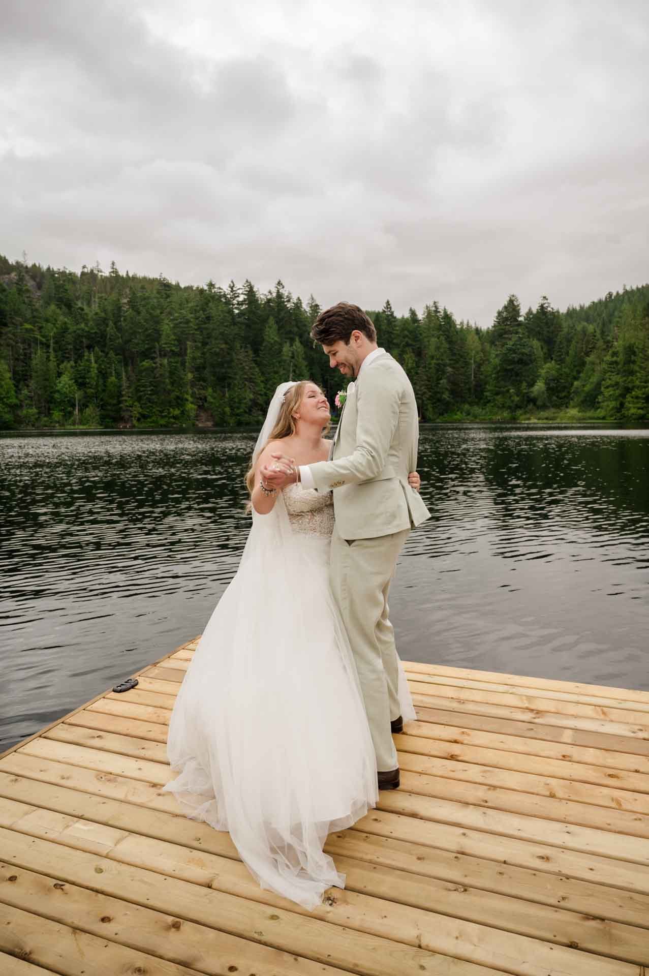 bride + groom's first dance on a floating dock in the middle of a lake
