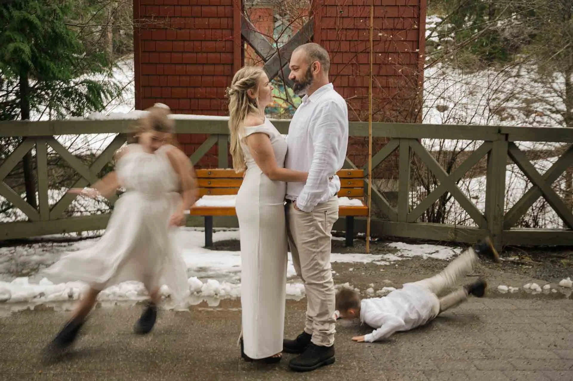 Bride + groom facing each other while their kids run around them