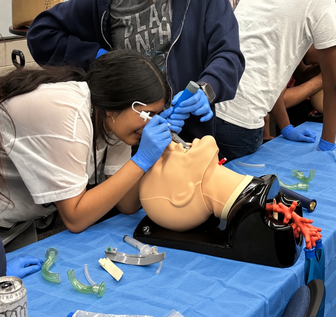 Intubation practice with blue drape and gloves.png