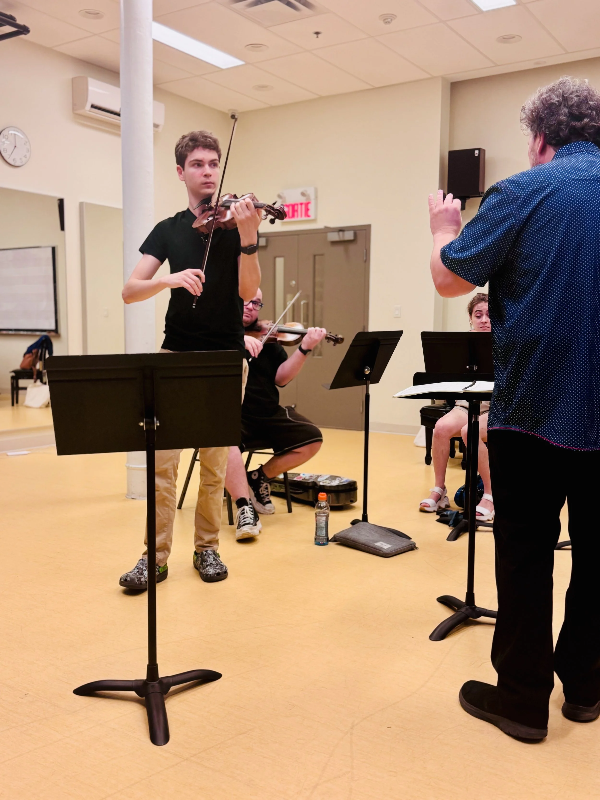 World-class guest artist mentoring a pre-college violinist during an AYAP masterclass.