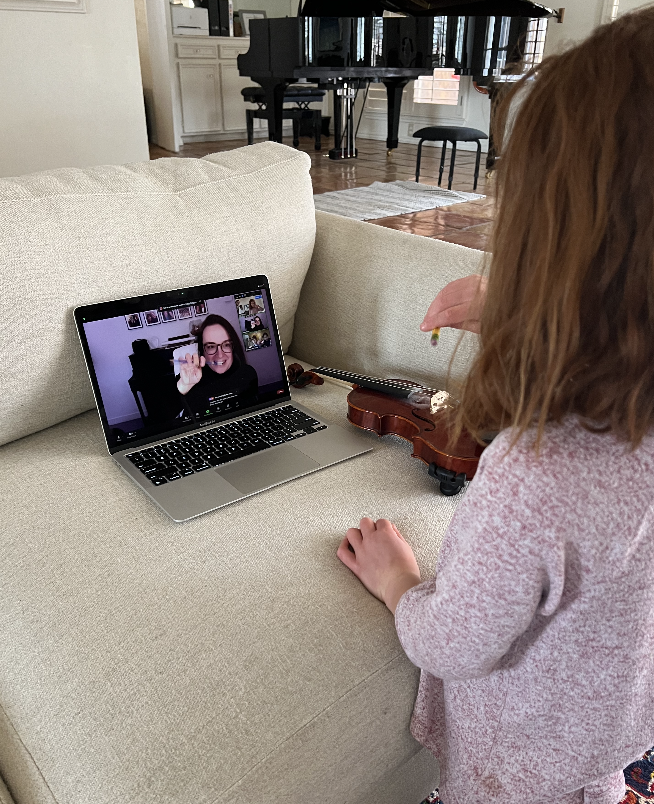 Very Young violinist practicing intently during an intensive preparation session for an audition.