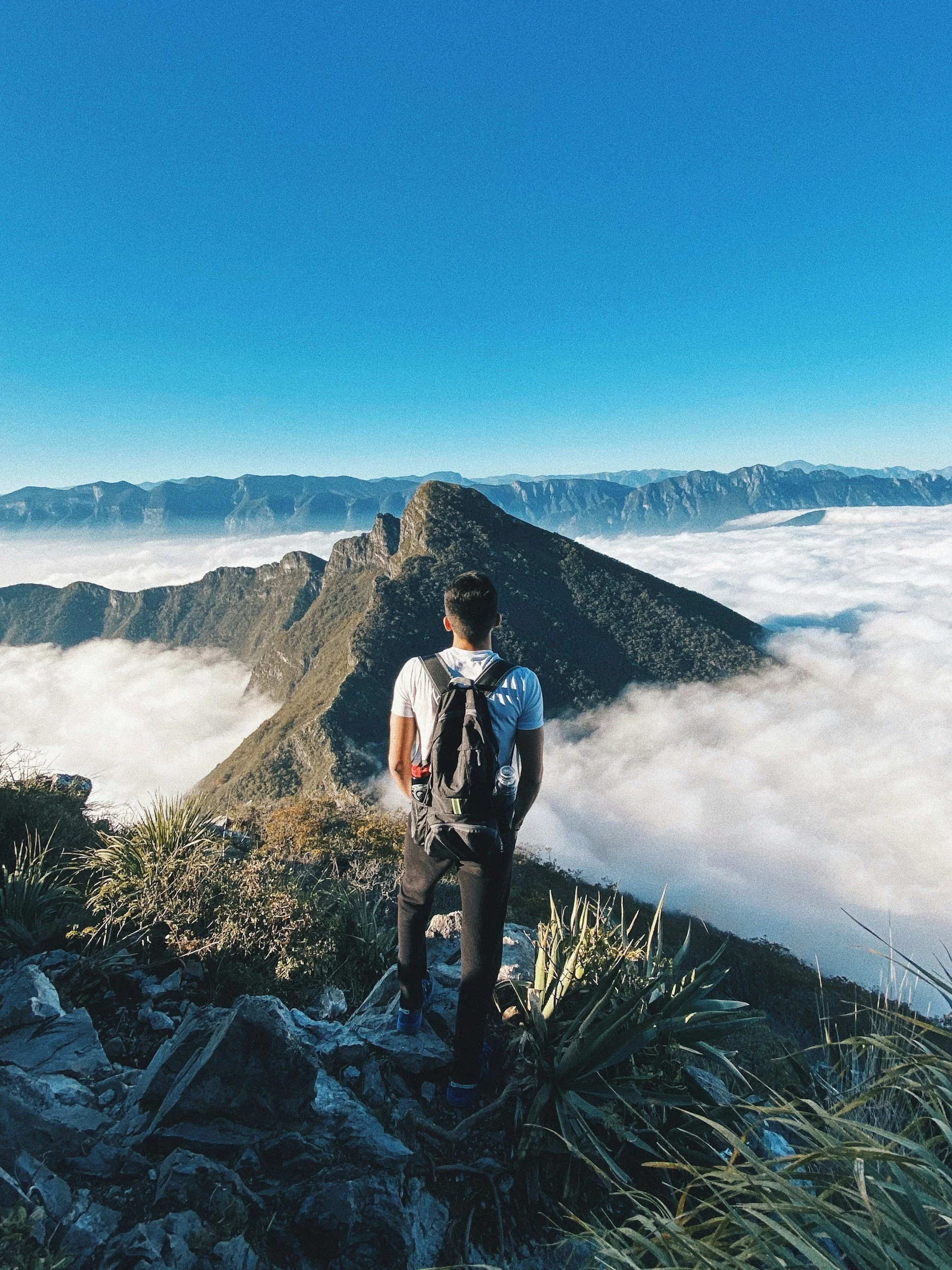A person reaching the top of a mountain