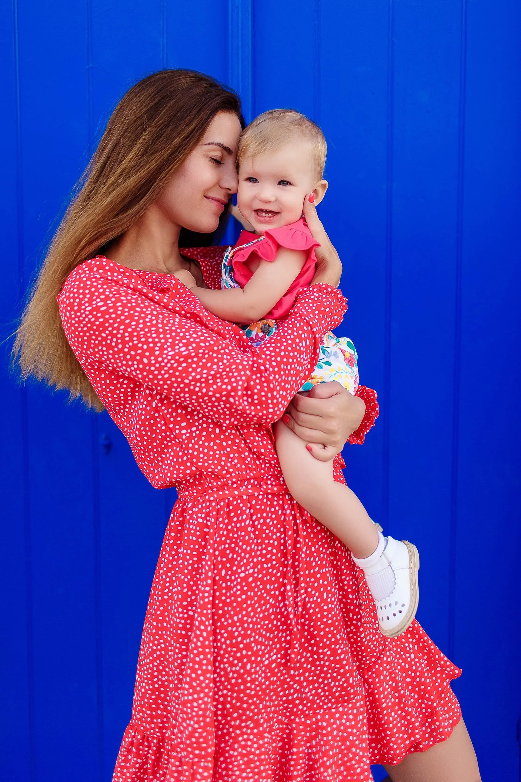 mother holding baby Protaras family photographer Cyprus bright colorful portrait