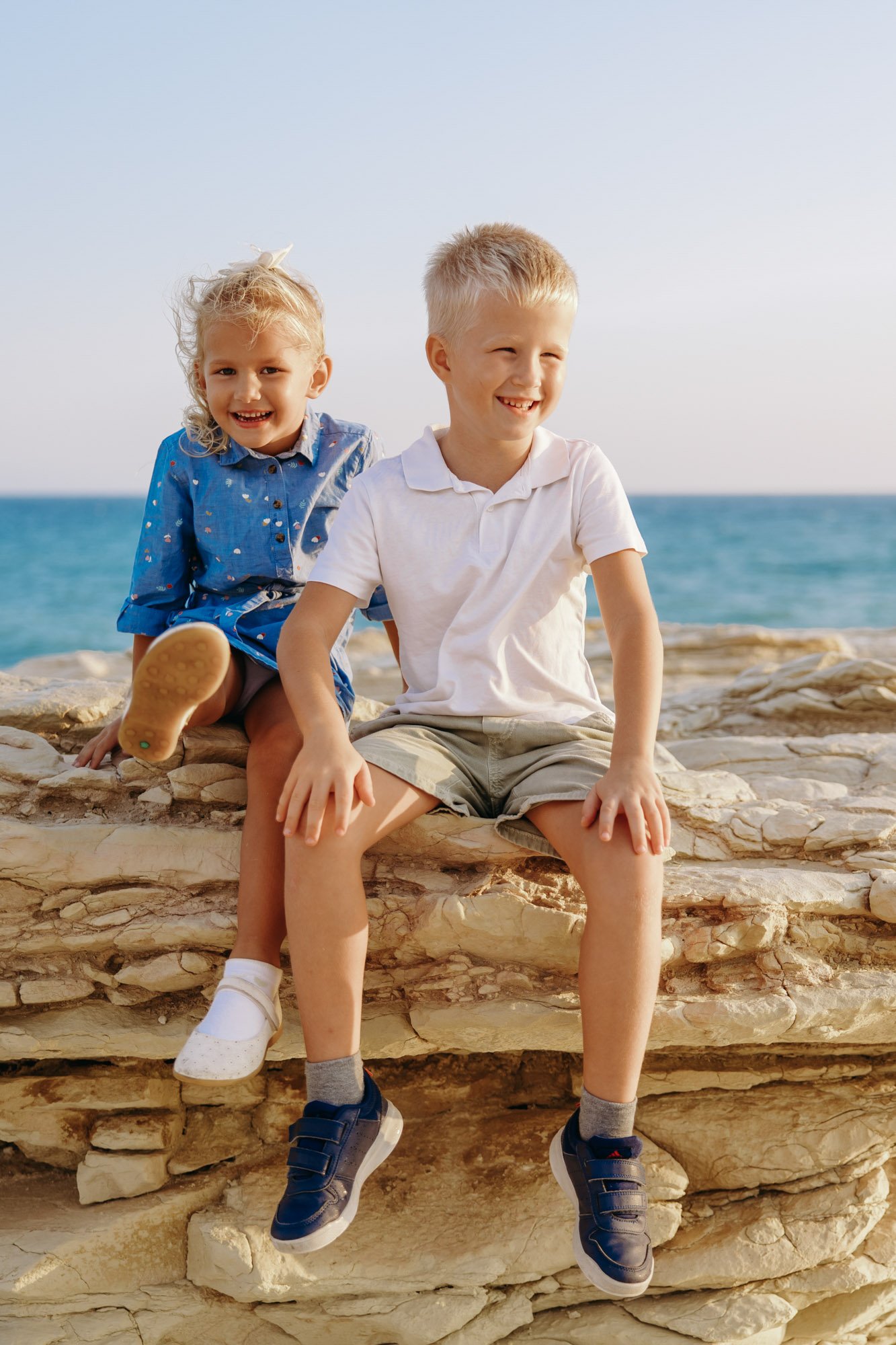 children sitting on rocks at White Stones Cyprus natural family photography Limassol coast