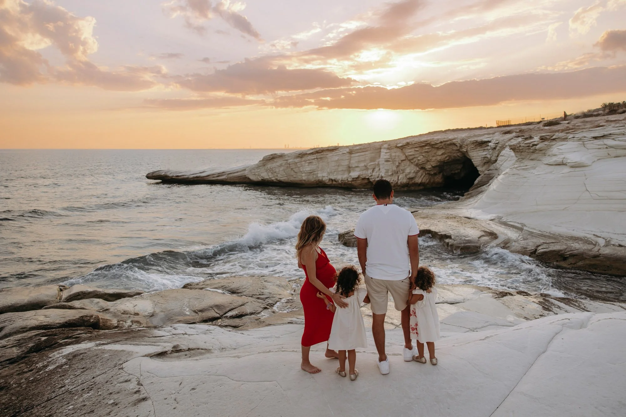 family photoshoot White Stones Limassol Cyprus walking on white rock coastline at sunset
