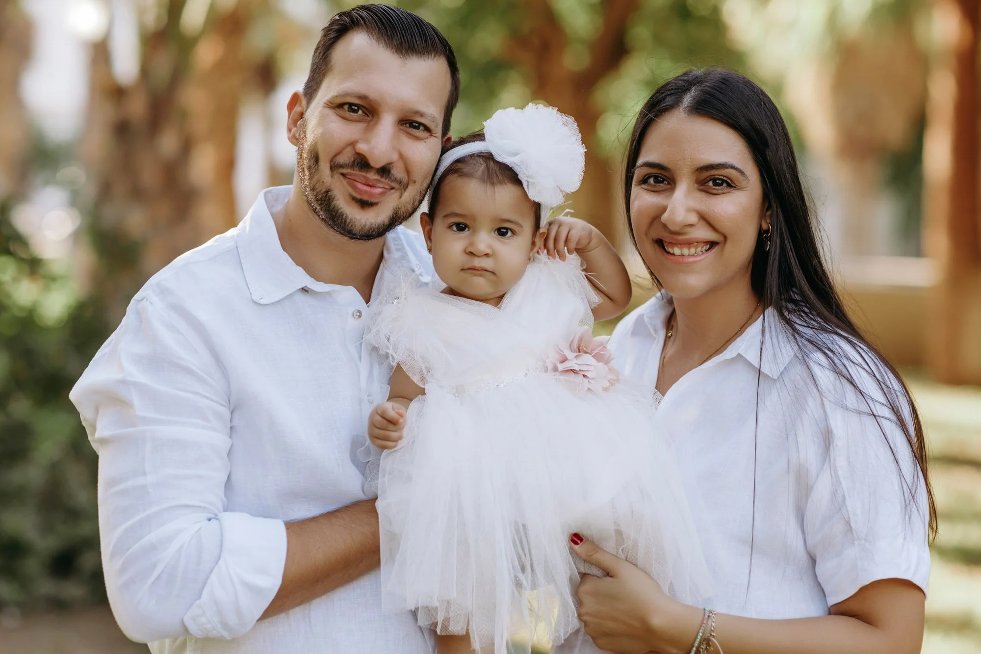 parents holding baby girl Nicosia family photographer Cyprus natural lifestyle portrait