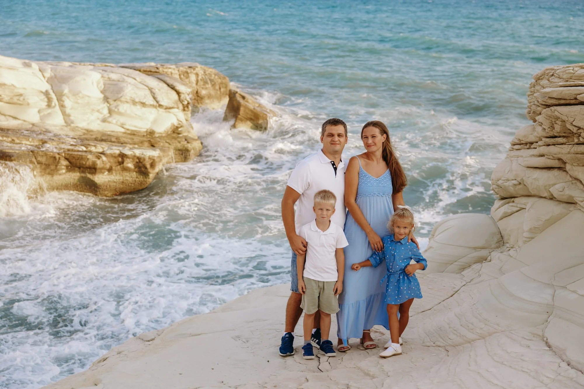 family standing on coastal rocks White Stones Limassol Cyprus dramatic sea view photography