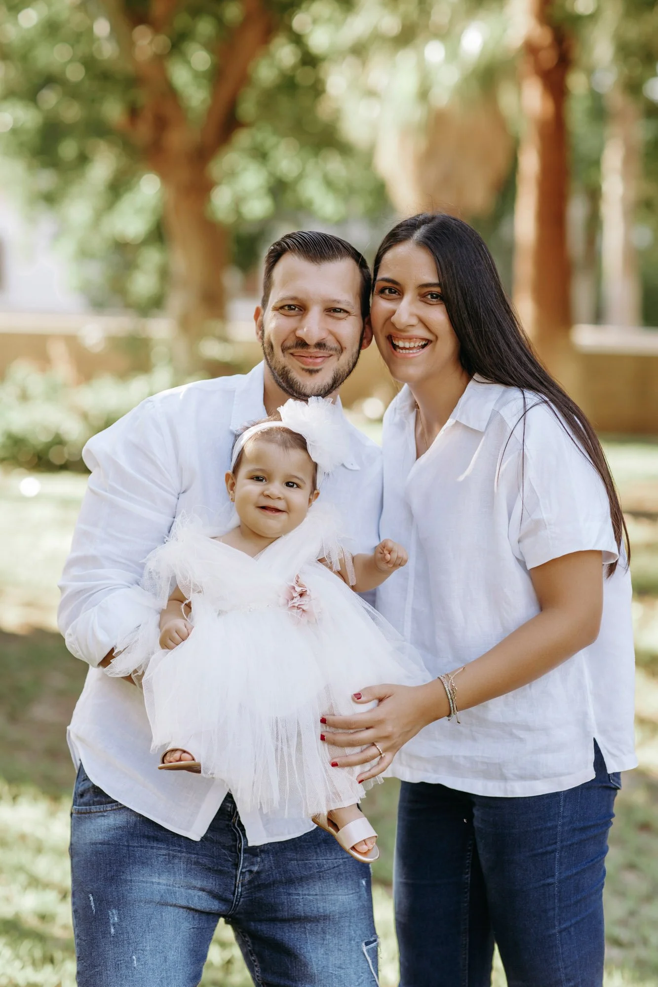 family portrait Nicosia Cyprus parents holding baby outdoor photoshoot