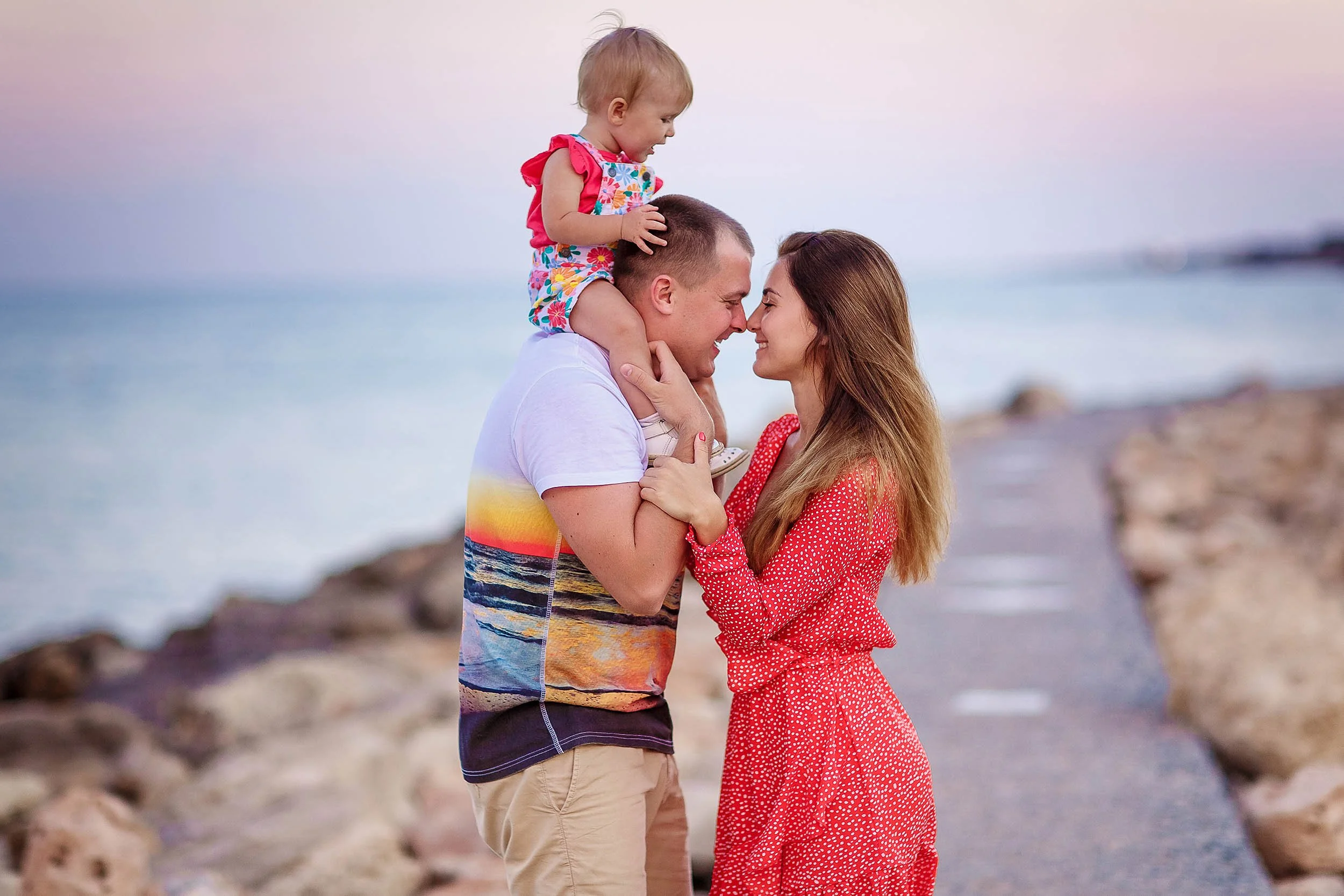 family kissing child during Protaras photoshoot Cyprus soft natural beach lighting