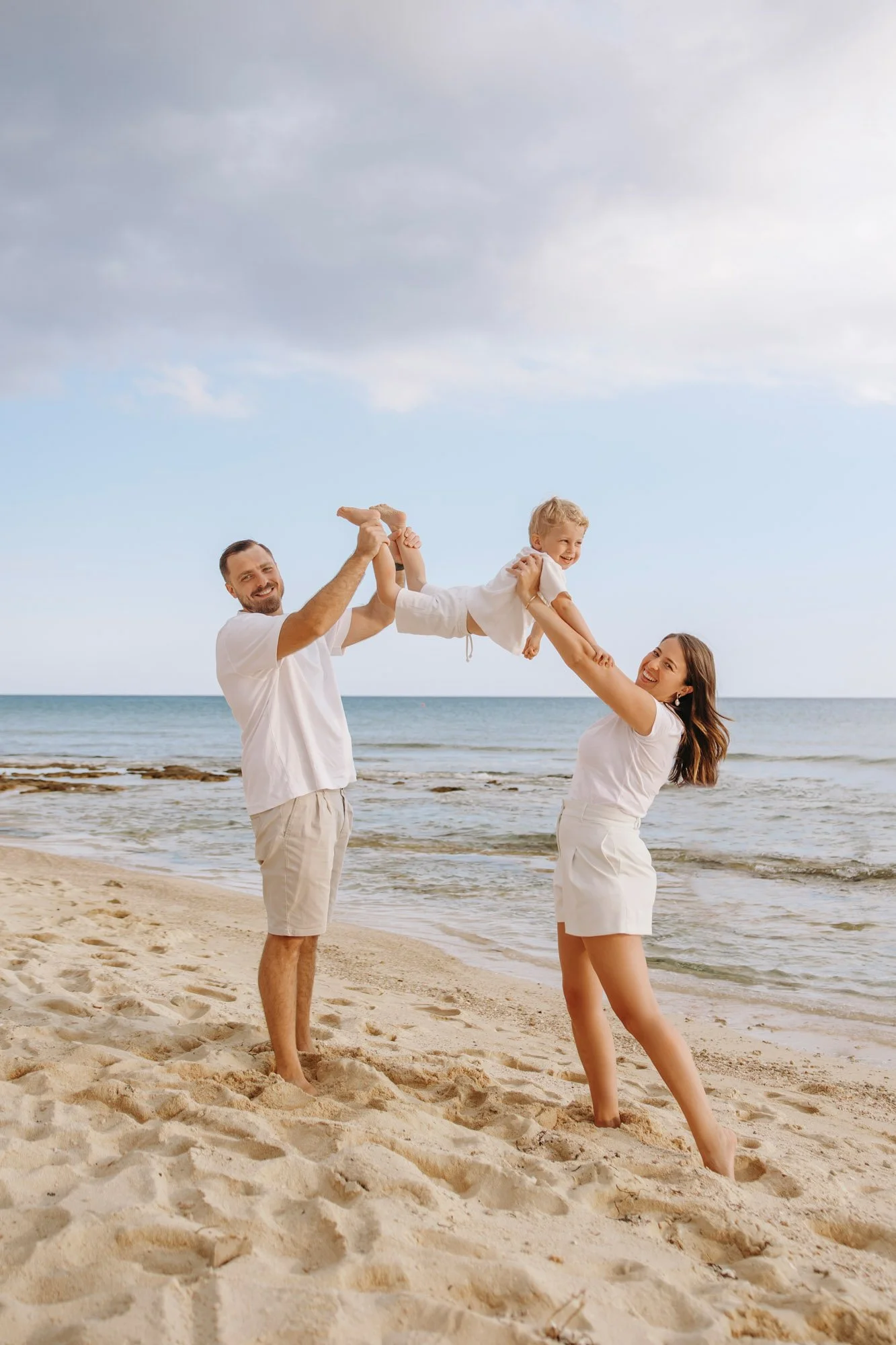 family photoshoot in Ayia Napa playing with kids on the beach at sunset