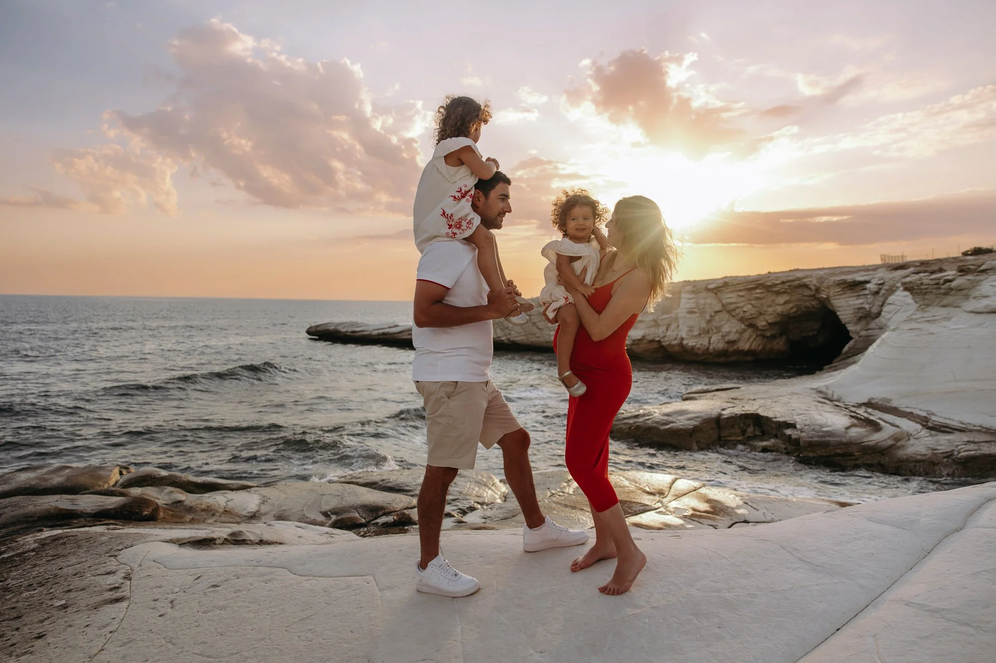 family holding children at sunset White Stones Limassol natural lifestyle photoshoot Cyprus
