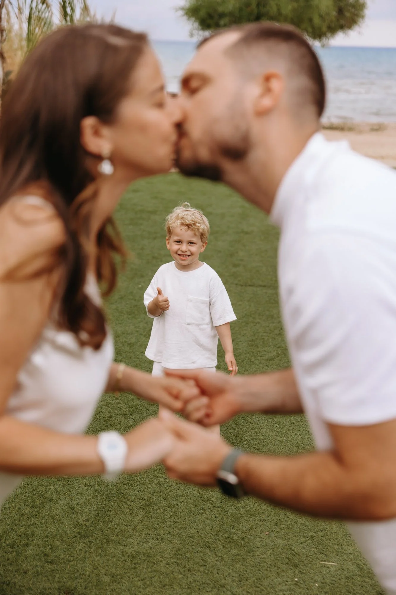 close emotional family moment Ayia Napa candid photography holding hands by the sea