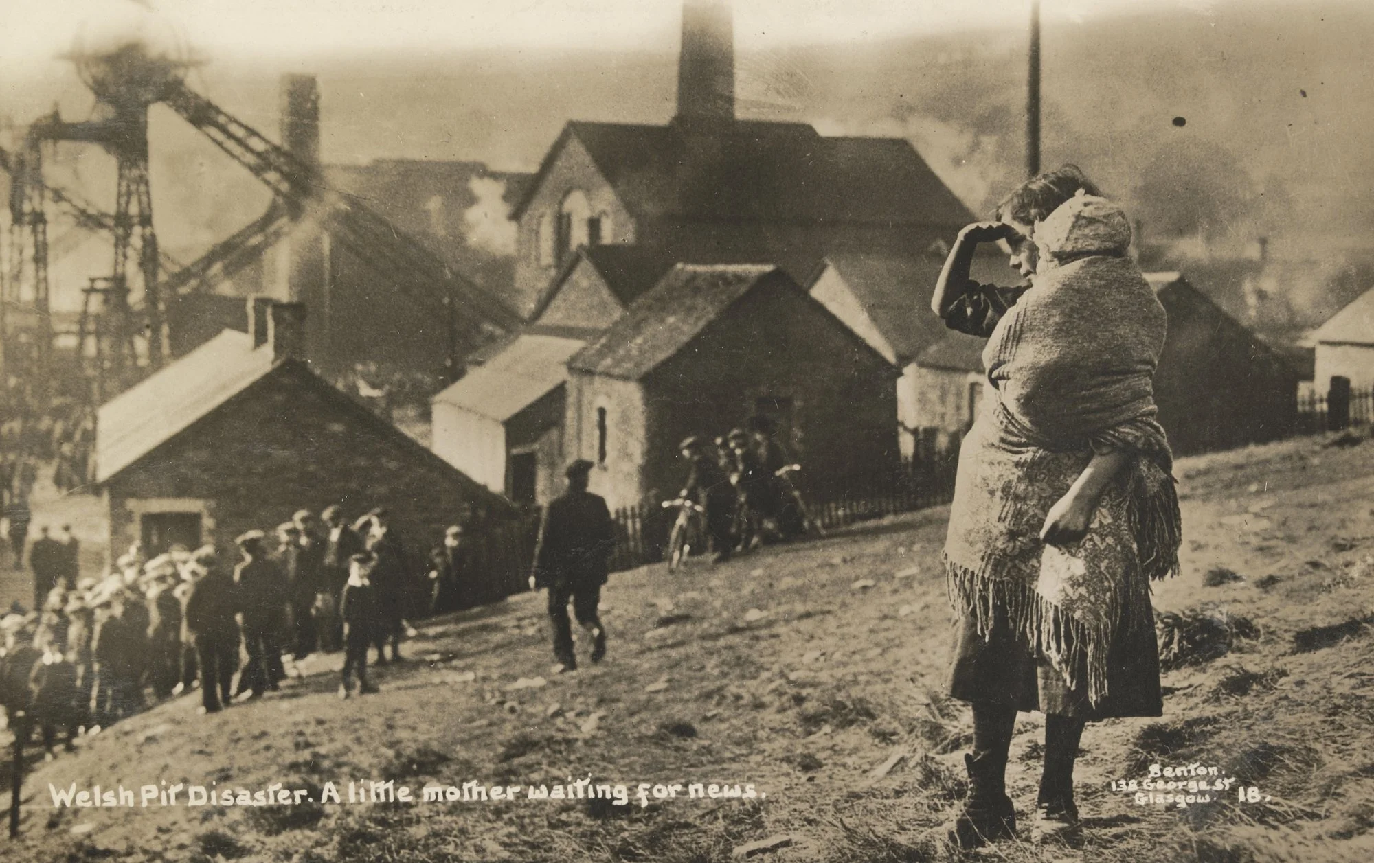 A young Welsh mother stands on a grassy hillside, shielding her eyes as she peers toward the coal mine below — searching, waiting, hoping. The year is 1913, and tragedy has struck the valley. Behind her, smoke rises from the mineworks, and a crowd of