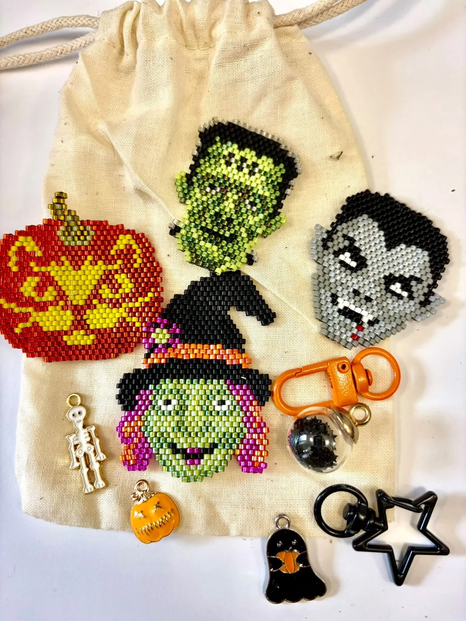 all four halloween brick stitch with charms.jpg