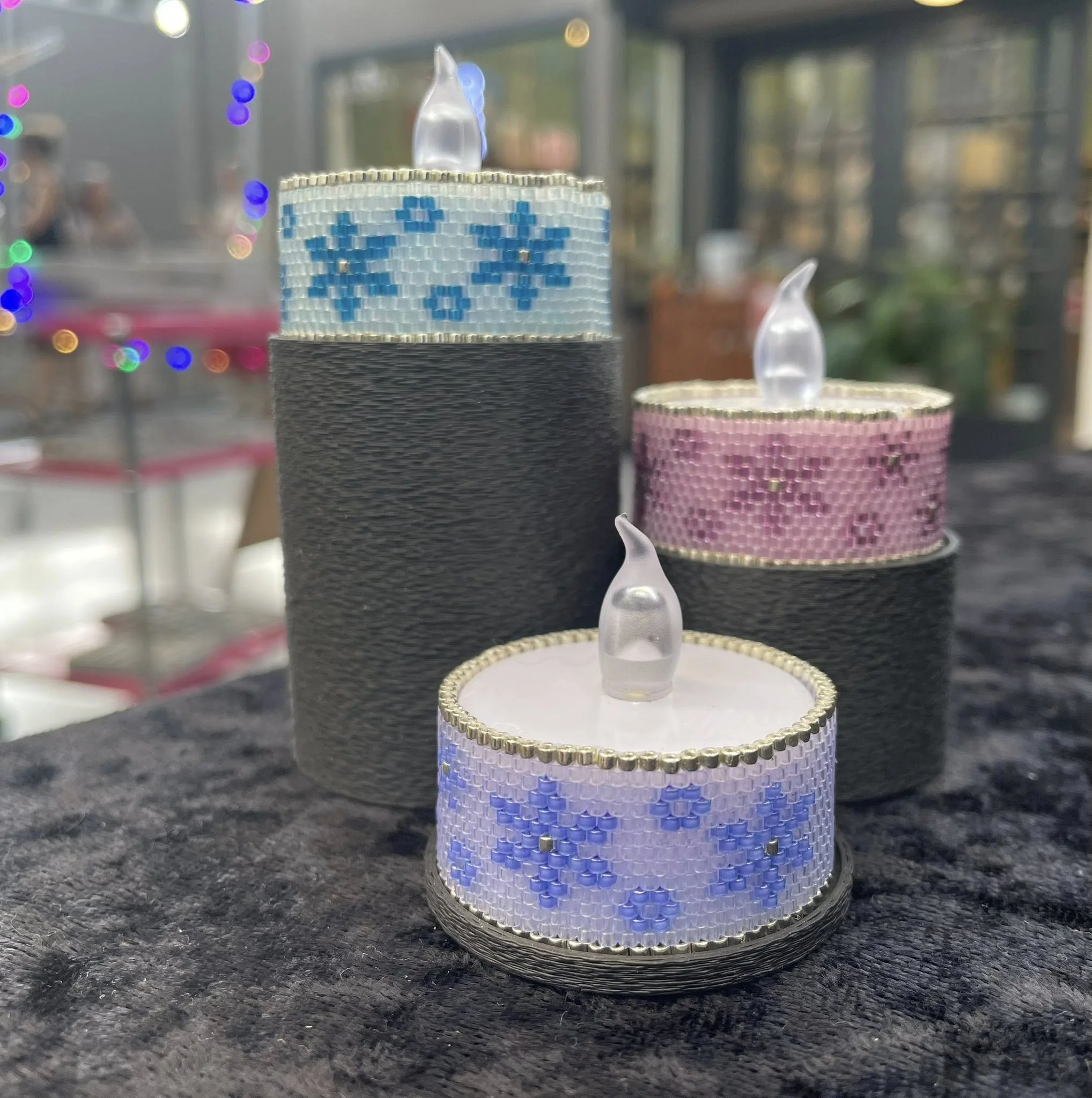 three snowflake tea lights 2025 on stand.jpg