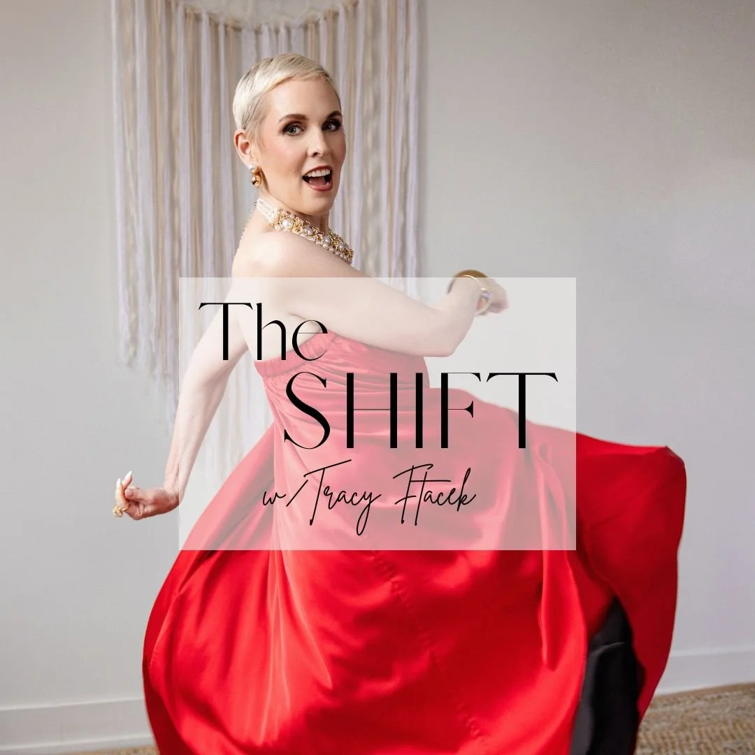 Woman with short blonde hair wearing a strapless pink dress and a pearl necklace, posing with a joyful expression in front of a plain wall with curtains, overlaid with text 'The Shift w/ Tracy Facelk'.