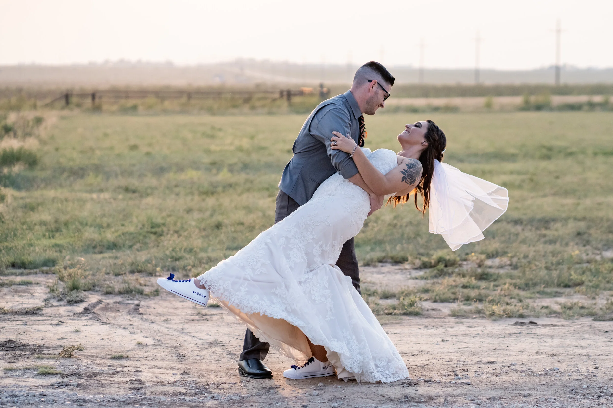 Bride and groom embracing during a golden hour sunset portrait session with an Amarillo wedding photographer.