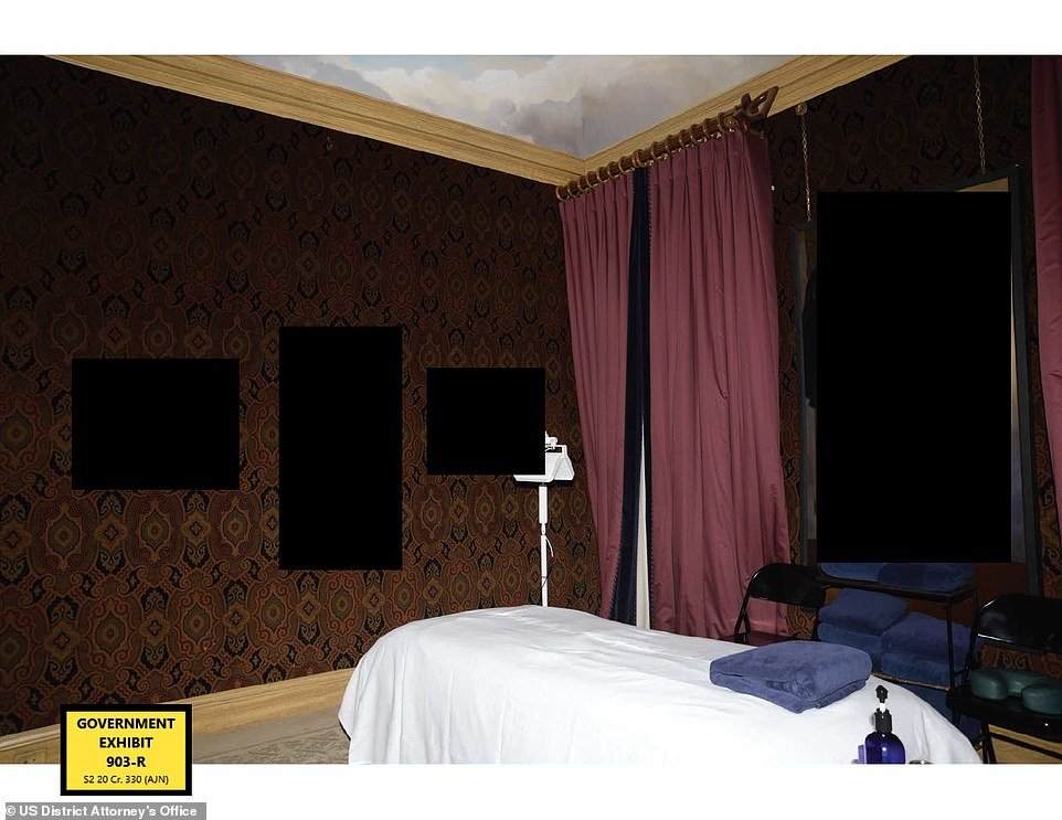  A massage table in the middle of the room and red curtains frame a large photo that’s been blacked out by authorities (government exhibit 903-R) 