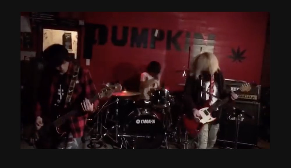  BYE BYE NEGATIVES performing one of their songs. Shogo is the one on the left in red plaid 