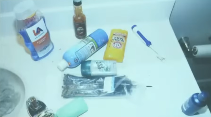  Counter of the bathroom. (camera is taken as part of the search warrant). The bottle of hot sauce up top, zip ties bottom center 