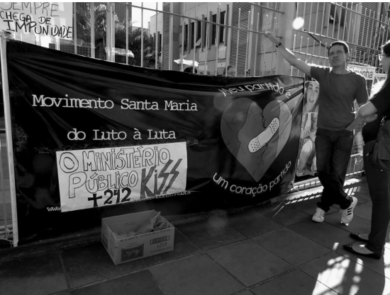  Protest in front of the public ministry building – it says “Movement Santa Maria – From grief to fight. Public ministry – 242 deaths – Kiss” 