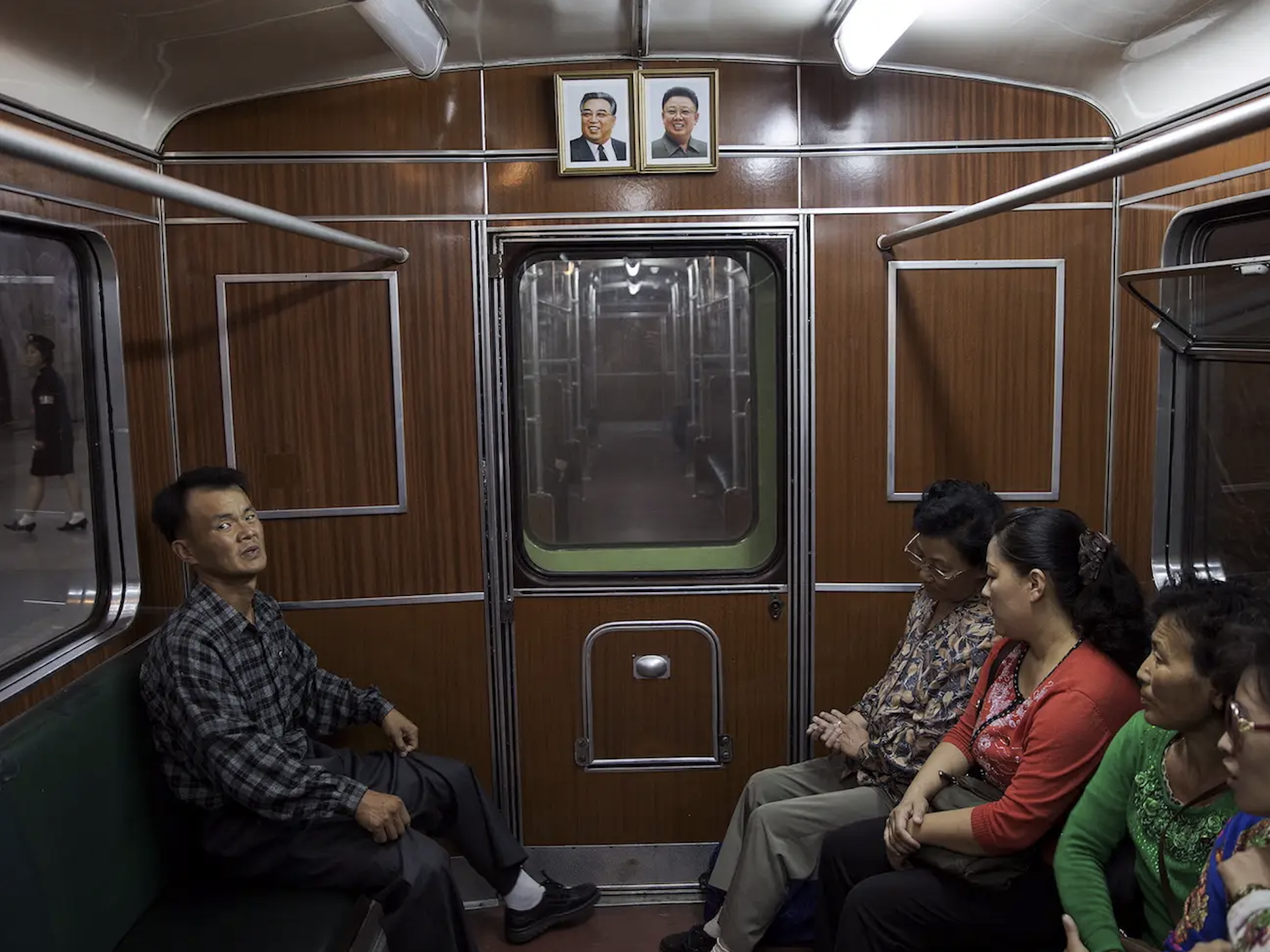  Each carriage contains portraits of Kim Il-Sung and Kim Jong-Il, framed thicker at the top to give the impression that the former leaders are looking over the commuters 