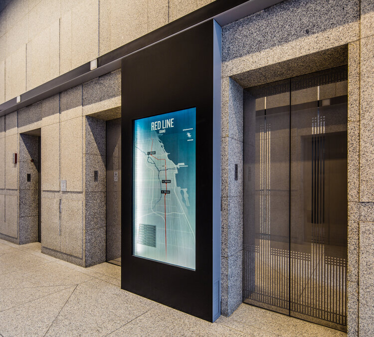 A branded elevator shows nearby public transit options.