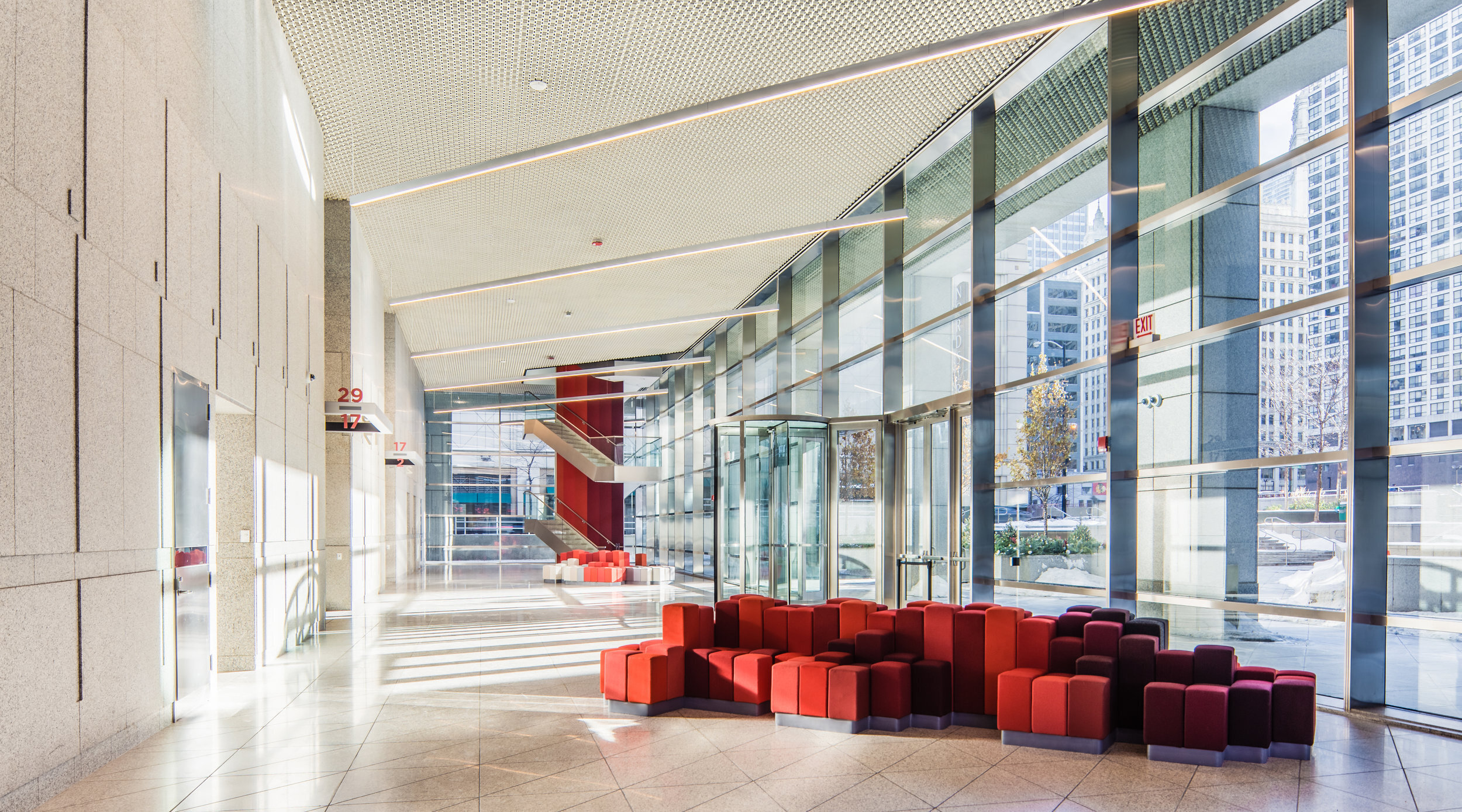 The lobby of 515 North State has tall bright windows and a dramatic sloping ceiling.