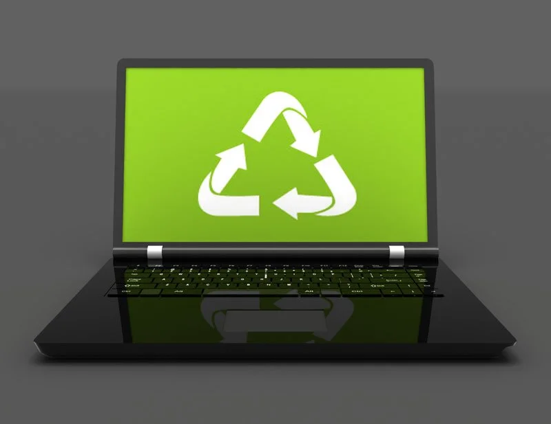 Laptop displaying a recycling symbol representing secure laptop disposal, IT asset disposition (ITAD), and responsible electronics recycling for businesses.