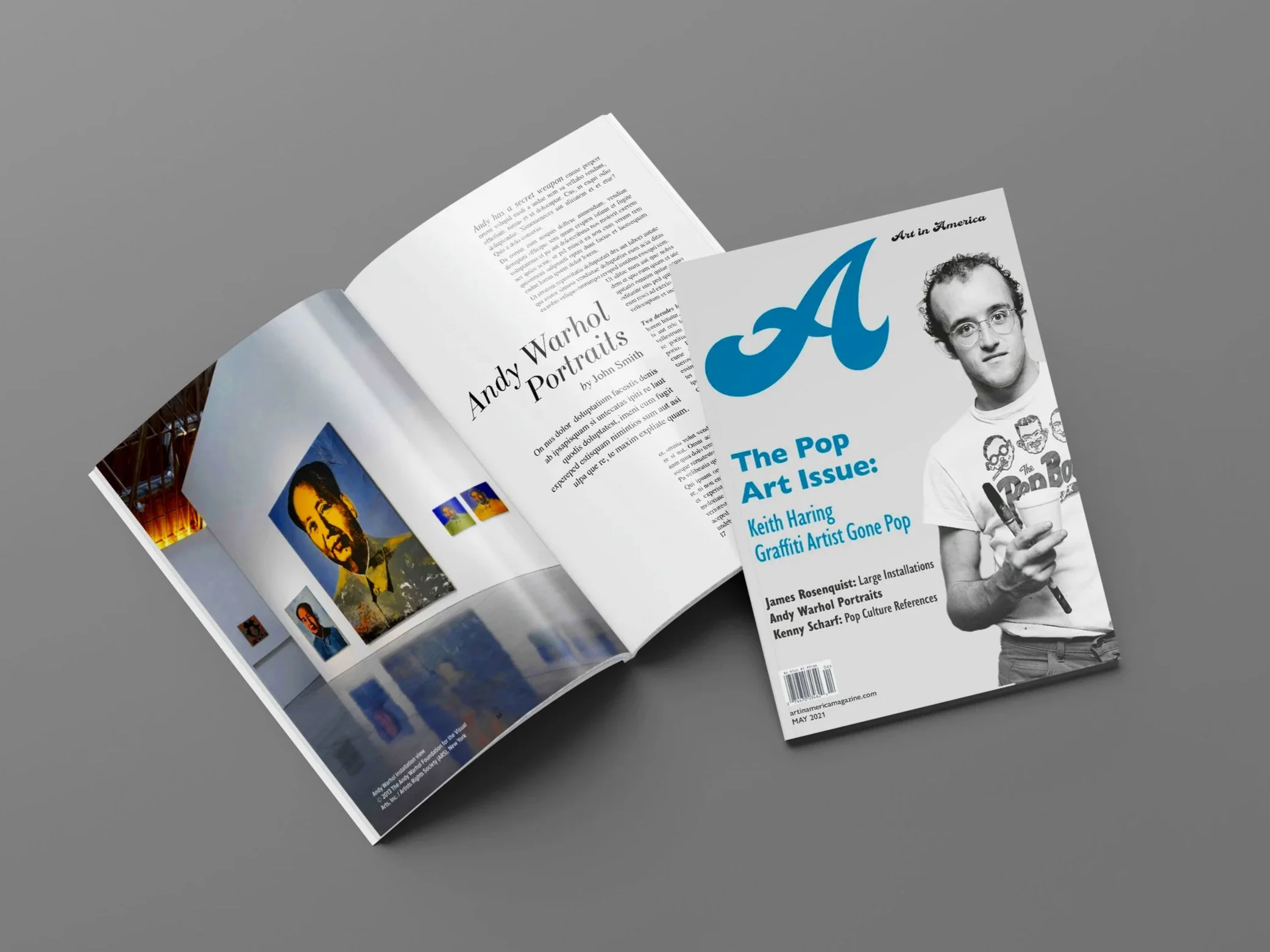 Open magazine featuring an article about Andy Warhol portraits, with images of Warhol's artwork and a black-and-white photo of him, on a gray surface.
