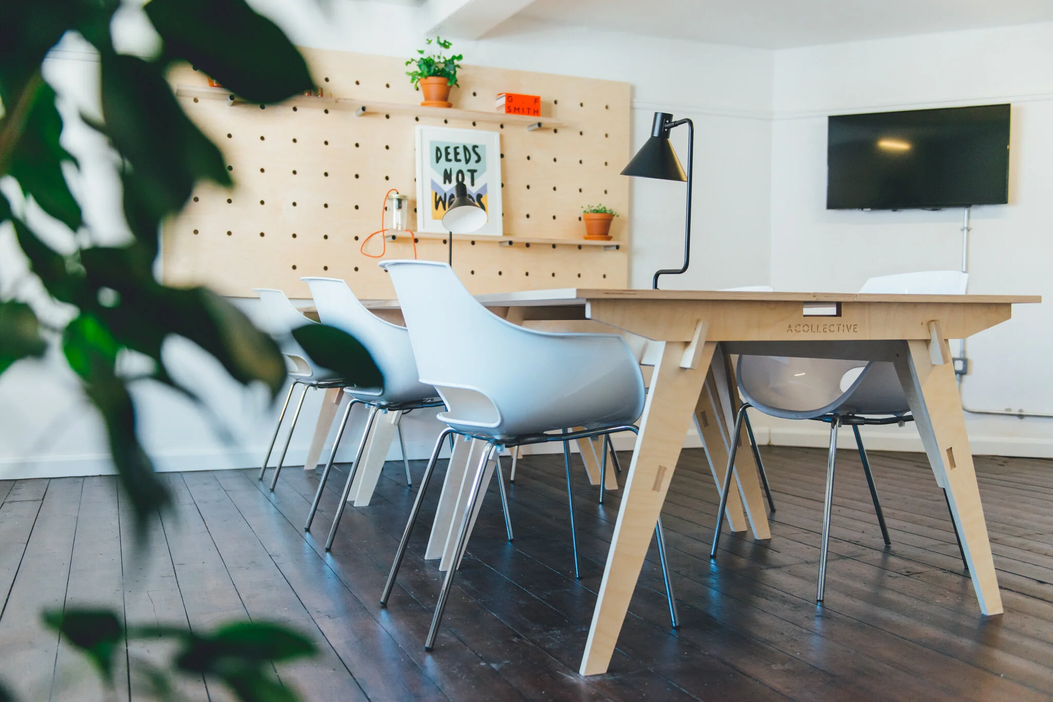 York city centre office – six person - with a wooden table and white chairs and a plant